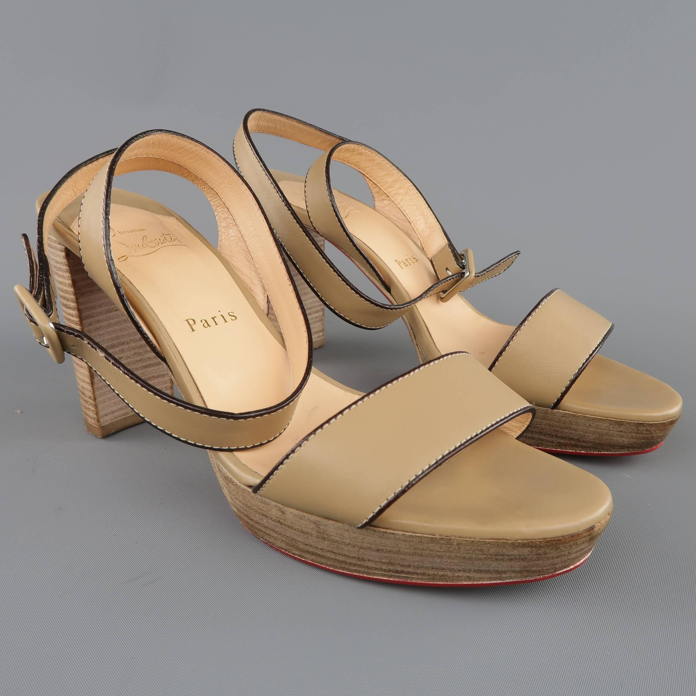 CHRISTIAN LOUBOUTIN sandals come in taupe beige smooth leather with dark brown piping and feature a wrapped ankle strap and chunky, stacked platform and heel. With box. Made in Italy.
 
Good Pre-Owned Condition.
Marked: IT 39
 
Measurements:
 
Heel: