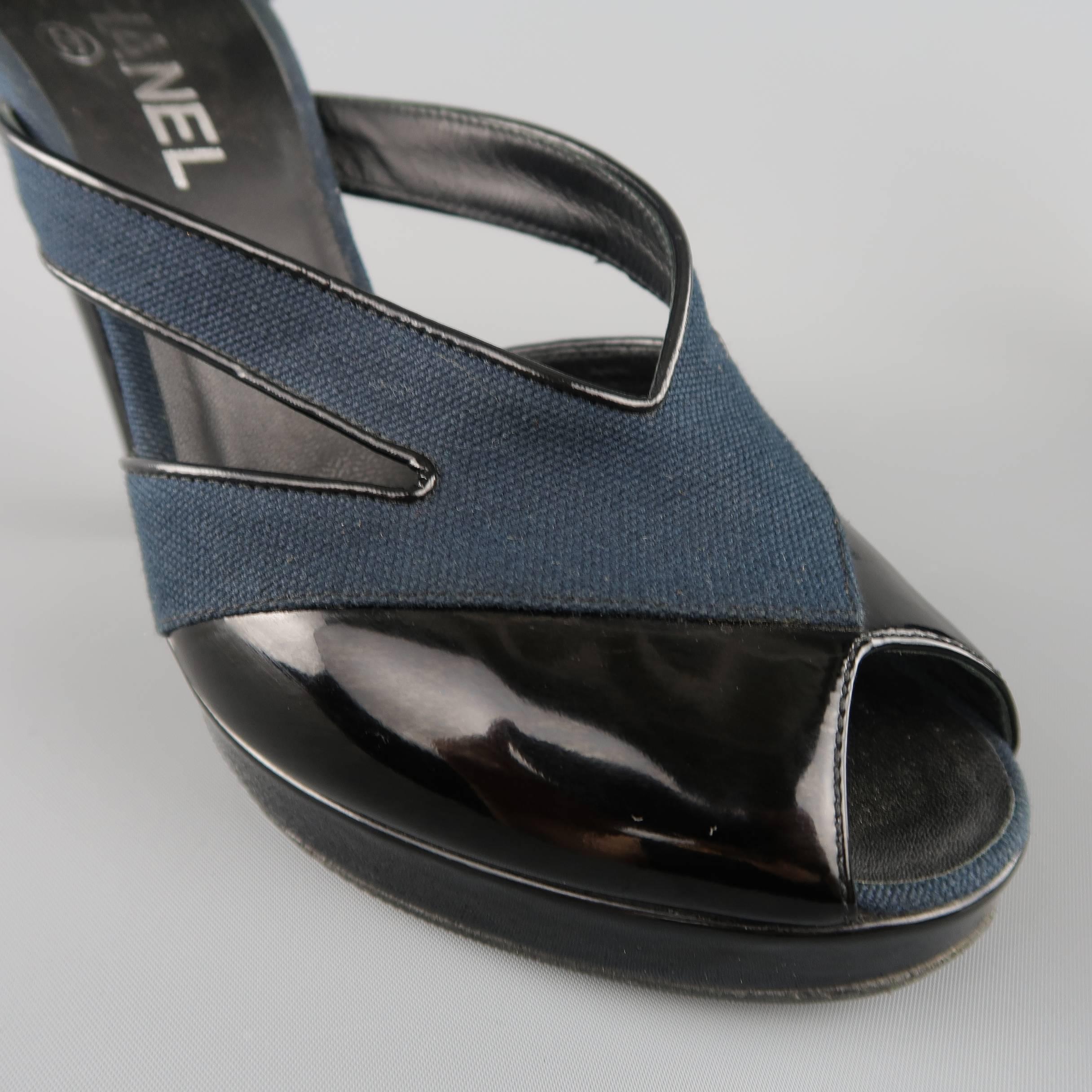 CHANEL pump sandals come in navy teal canvas and feature cutouts with patent leather piping, Mary Jane ankle strap, peep toe with patent leather covered platform, silver tone CC logo, and chunky, structural heel. Made in Italy.
 
Good Pre-Owned