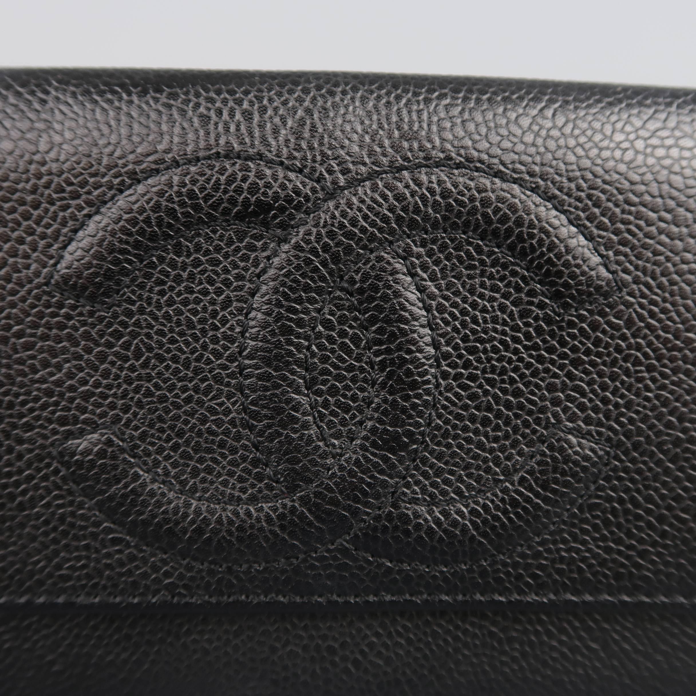 Classic vintage CHANEL envelope wallet comes in black caviar textured leather and features a large embroidered CC logo, flap snap closure, and lots of internal storage. Made in Italy.
 
Good Pre-Owned Condition.
 
Length: 7.75 in.
Width: 0.5