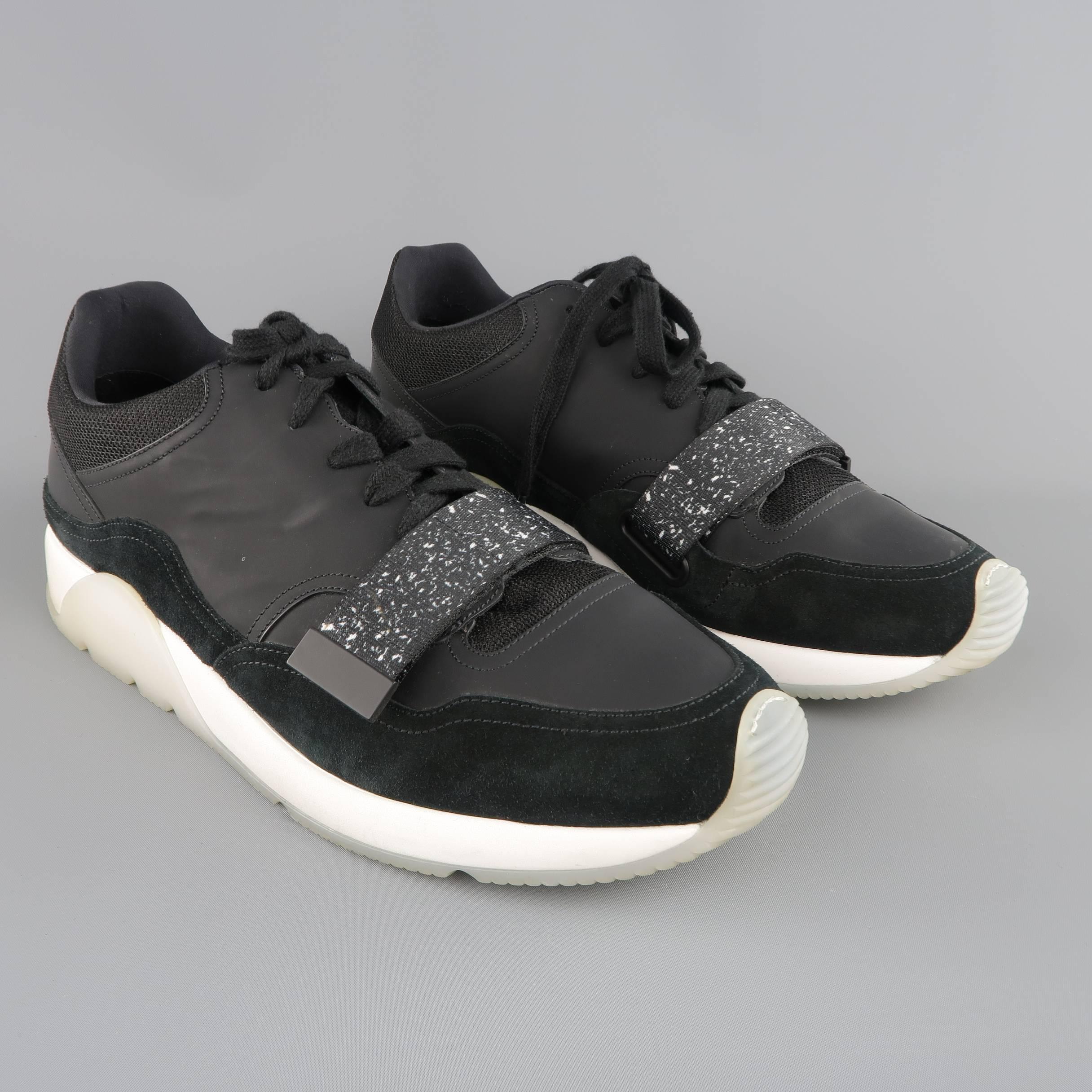 DIOR HOMME Spring 2015 lace up sneakers come in black rubberized leather with suede and mesh panels with a white and clear platform trainer sole and black and white speckled velcro strap. Minor Wear. Made in Italy.
 
Good Pre-Owned