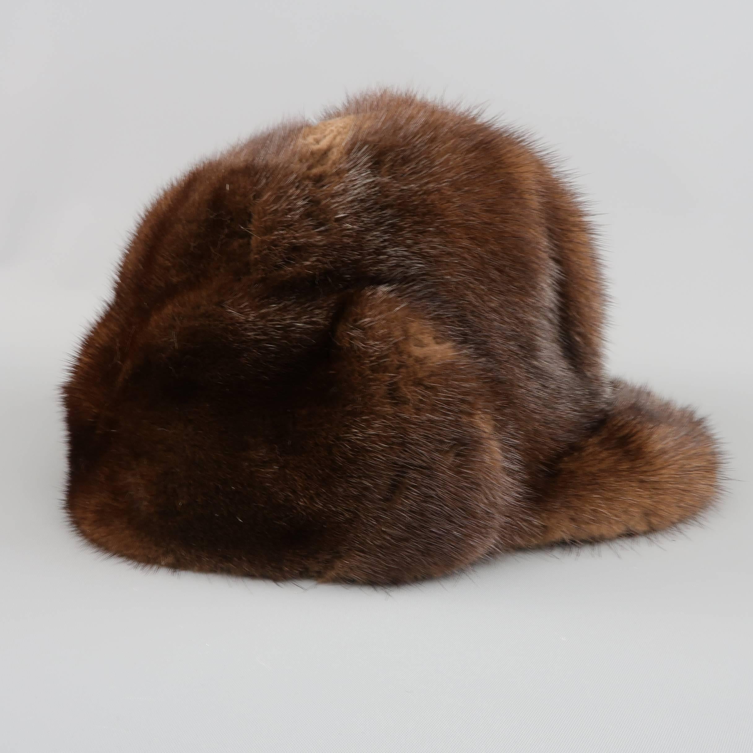 Vintage winter cap in brown mink fur with a brim and knit era cover. Wear on fur and lining. As-Is.
 
Fair Pre-Owned Condition.
 
Fits: 23 in.
Height: 6.5 in.
Brim: 2.5 in.

SKU: 83681