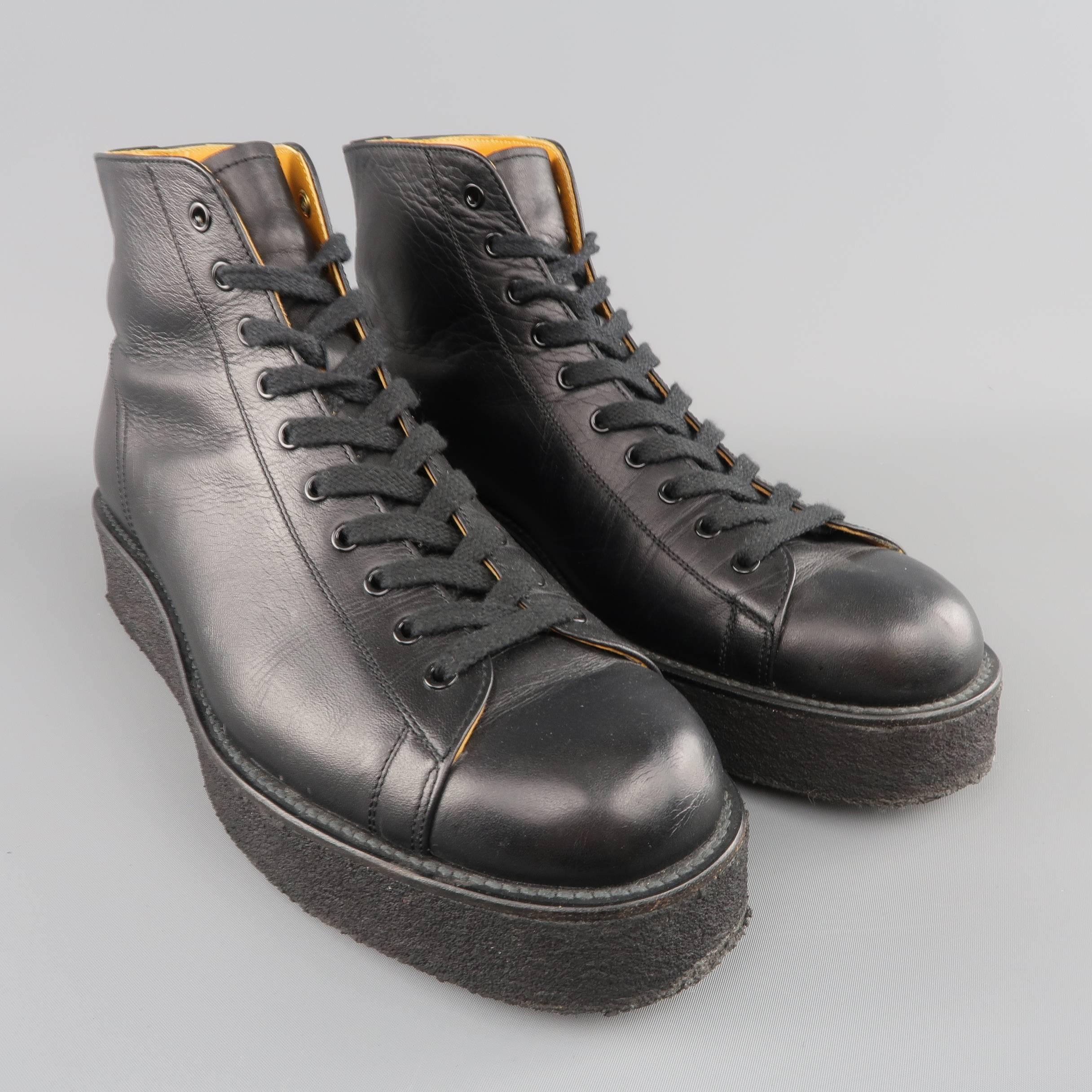 YOHJI YAMAMOTO ankle sneaker boots come smooth black leather and feature a round toe, black grommet lace up front, and thick, platform crepe sole. Made in Japan.
 
Good Pre-Owned Condition.
Marked: 10
 
Outsole: 12 x 4.25 in.
Platform: 1.5 in.

SKU: