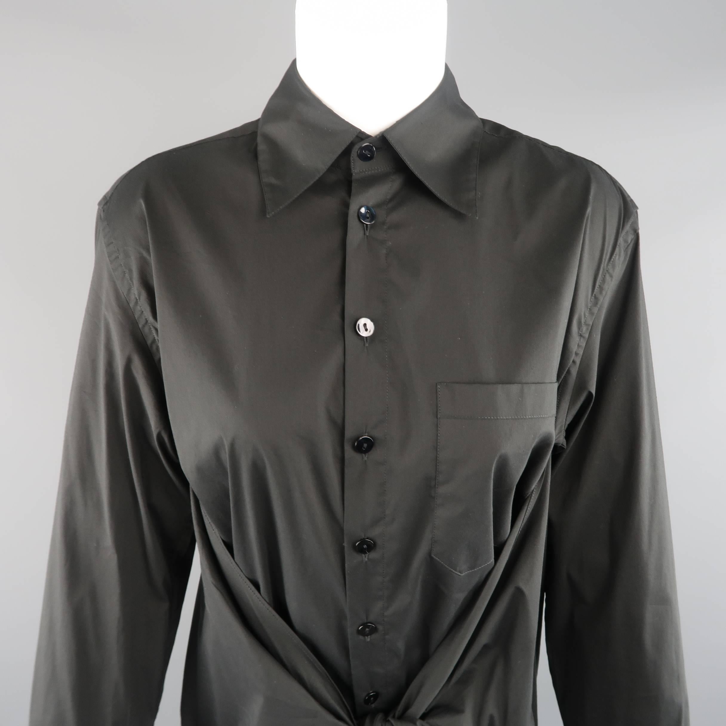 JEAN PAUL GAULTIER shirt comes in black stretch cotton and features a classic pointed collar, button up closure, and wrap tied front detail. Made in Italy.
 
Excellent Pre-Owned Condition.
Marked: US 10
 
Measurements:
 
Shoulder: 17.5 in.
Bust: 44