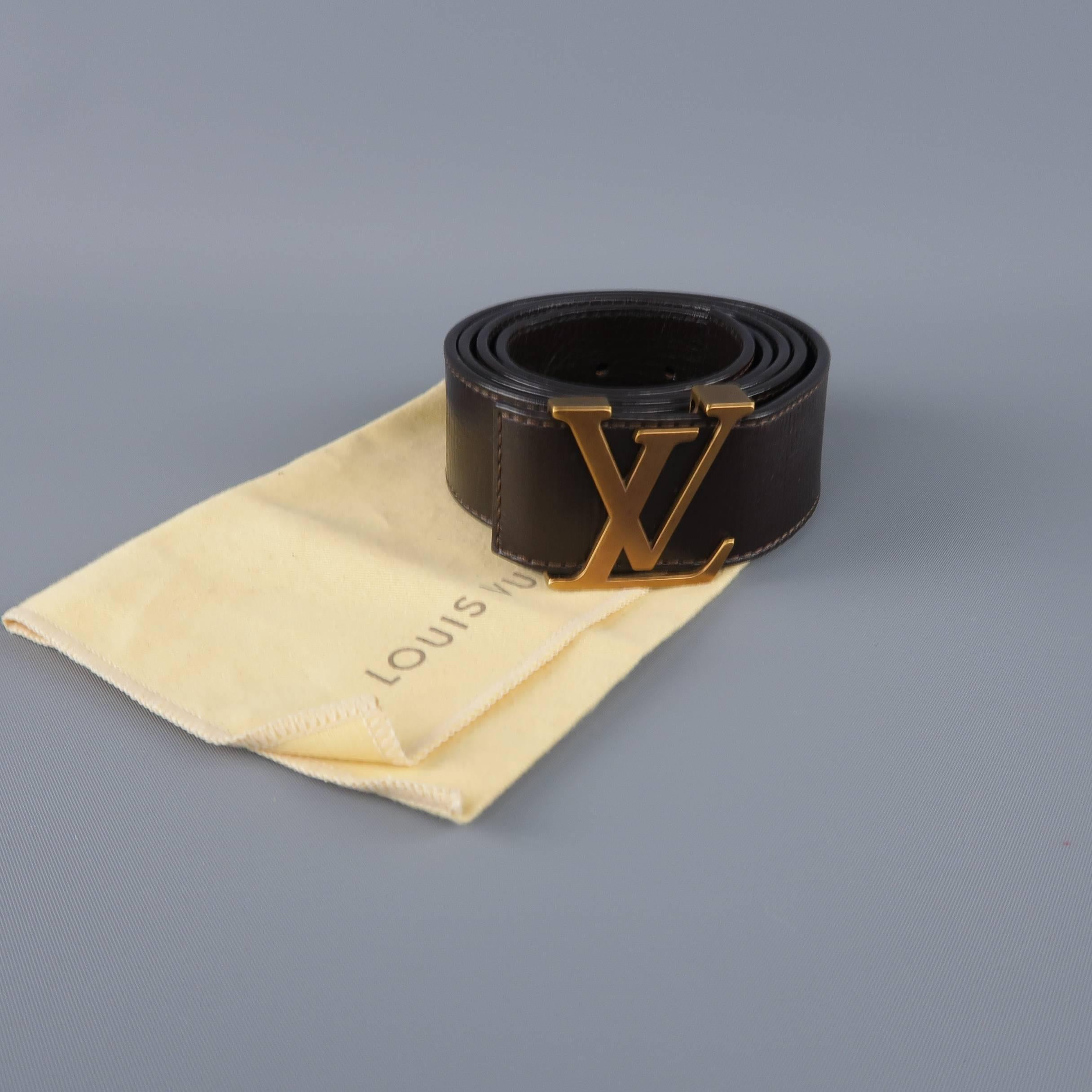 Classic LOUIS VUITTON belt features a thick chocolate brown Utah leather strap with dark antique gold tone brass LV monogram buckle. With dust bag. Made in Spain.
 
Excellent Pre-Owned Condition.
Marked: 110/44
 
Length: 50 in.
Width: 1.5 in.
Fits: