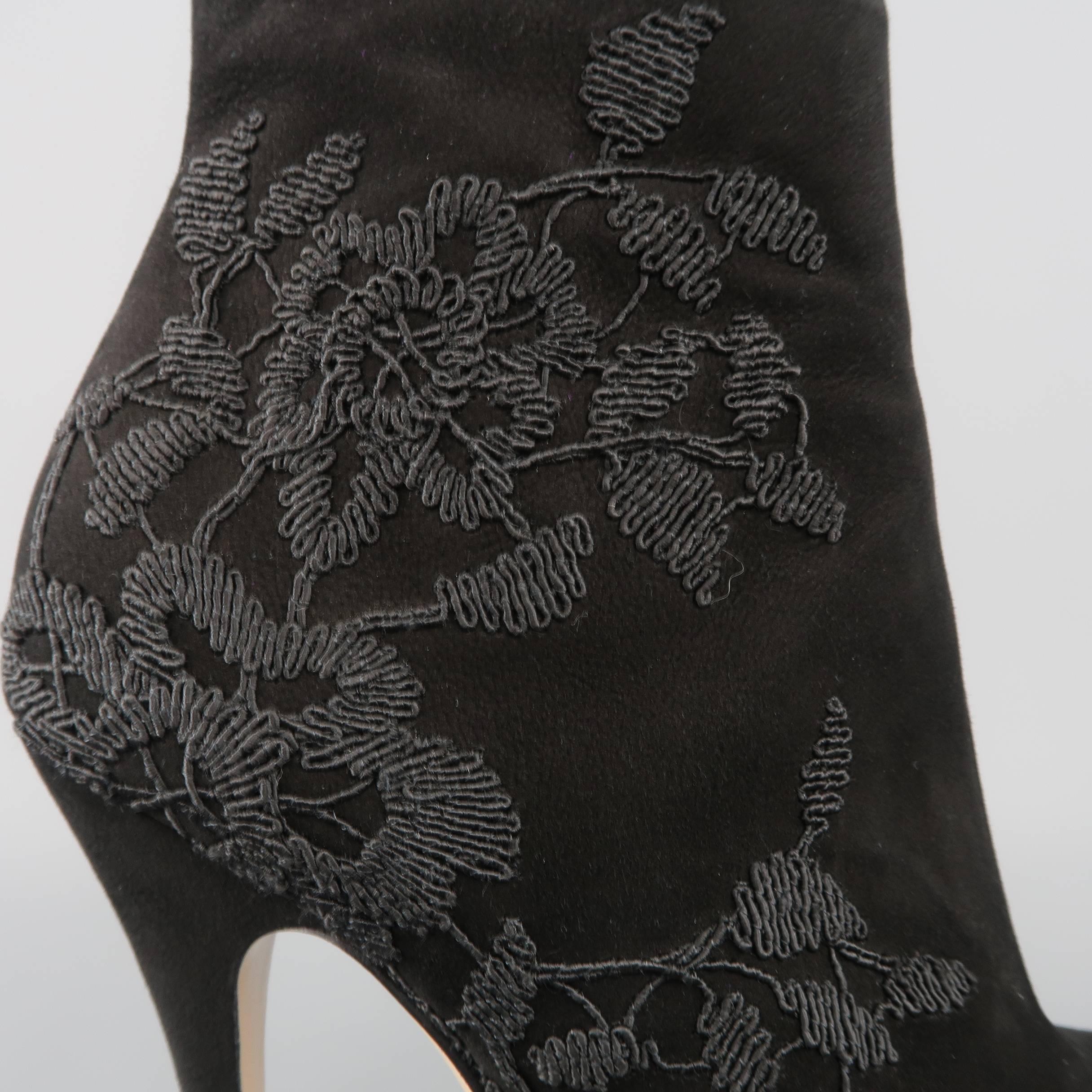 VALENTINO ankle booties come in black suede and feature a rounded point toe, concealed platform, covered stiletto heel, and lace appliques. Made in Italy.
 
Good Pre-Owned Condition.
Marked: IT 38.5
 
Measurements:
 
Heel: 4.75 in.
Platform: 1