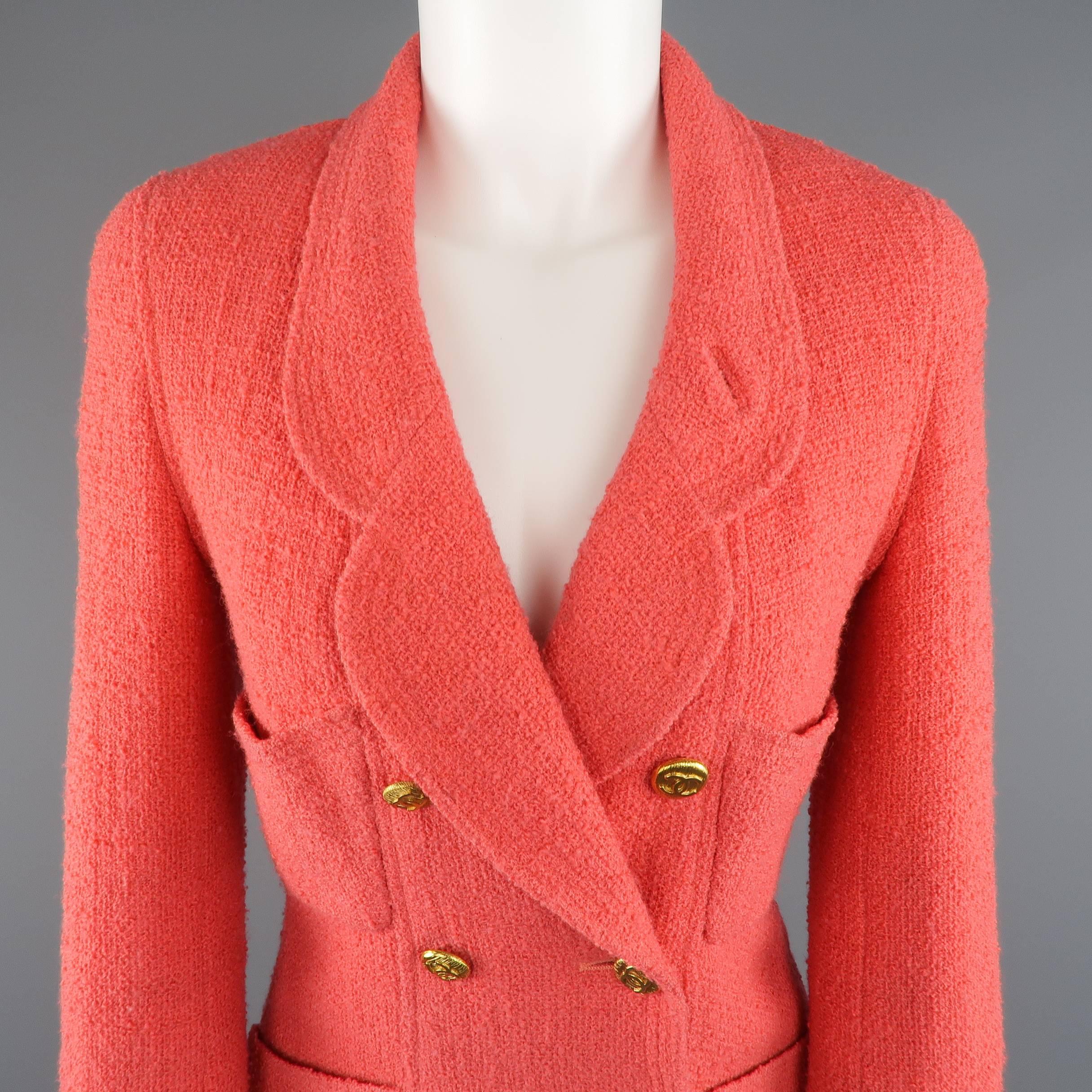 Vintage 1980's CHANEL jacket comes in a gorgeous coral wool tweed boucle and features a rounded lapel, double breasted front with iconic yellow gold tone CC buttons, patch pockets, and functional button cuffs. Minimal wear. Made in France.
