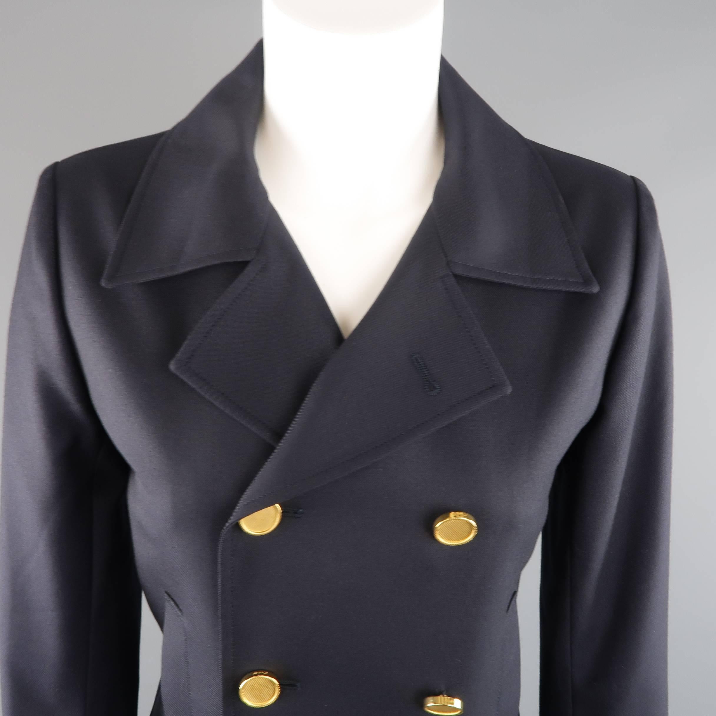SAINT LAURENT by Hedi Slimane cropped jacket comes in navy wool twill and features a pointed lapel, slit pockets, and double breasted front with gold tone metal buttons. Made in Italy.
 
Excellent Pre-Owned Condition.
Marked: F38
 
Measurements:

