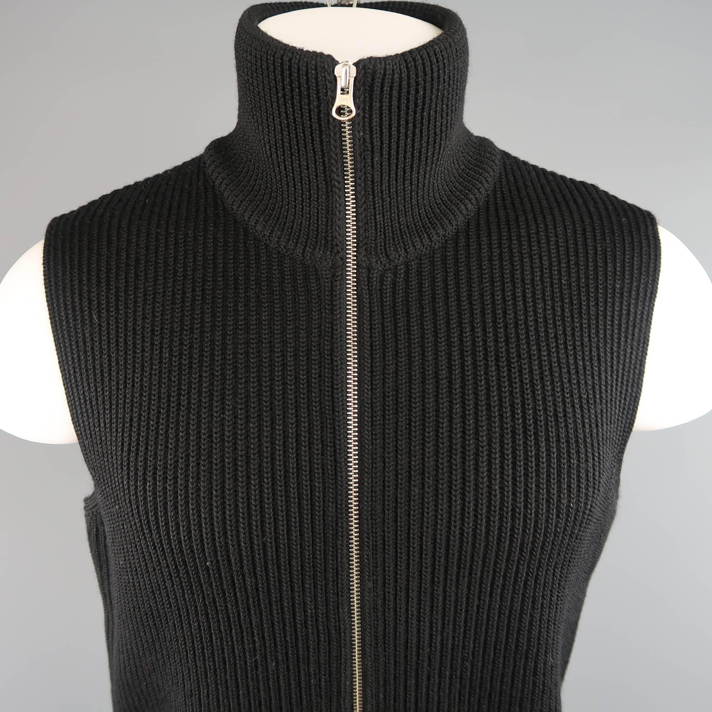 MAISON MARTIN MARGIELA sweater vest comes in a wool thick ribbed knit and features a high neck, zip front, and white stitched on back. Made in Italy.
 
Excellent Pre-Owned Condition.
Marked: M
 
Measurements:
 
Shoulder: 17 in.
Chest: 42 in.
Length: