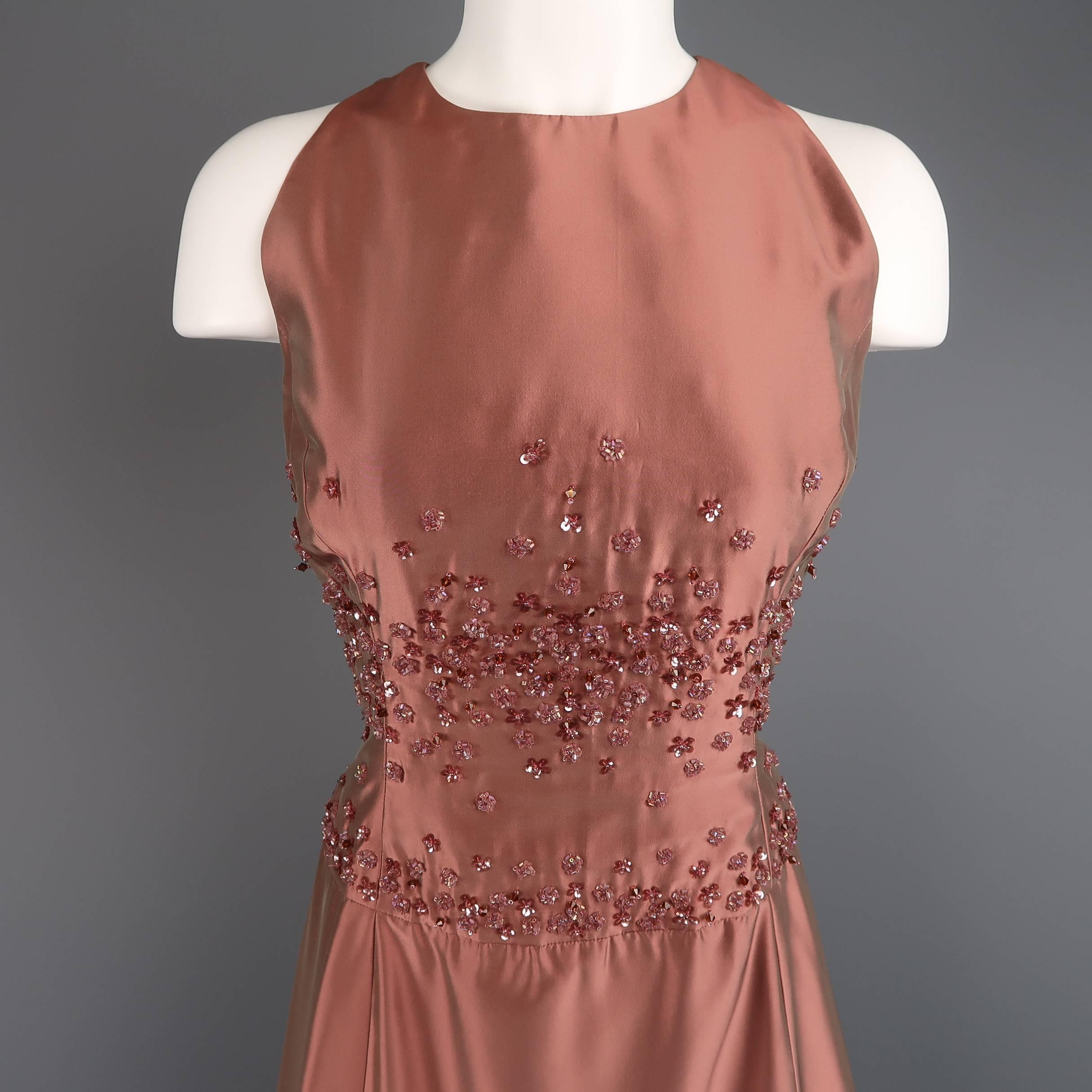 BADGLEY MISCHKA sleeveless evening gown comes in a dusty rose iridescent silk taffeta and features a round neckline, full length A line skirt, and floral beadwork through the bodice. Stain on side near hem and small spot on front. As-Is. Made in