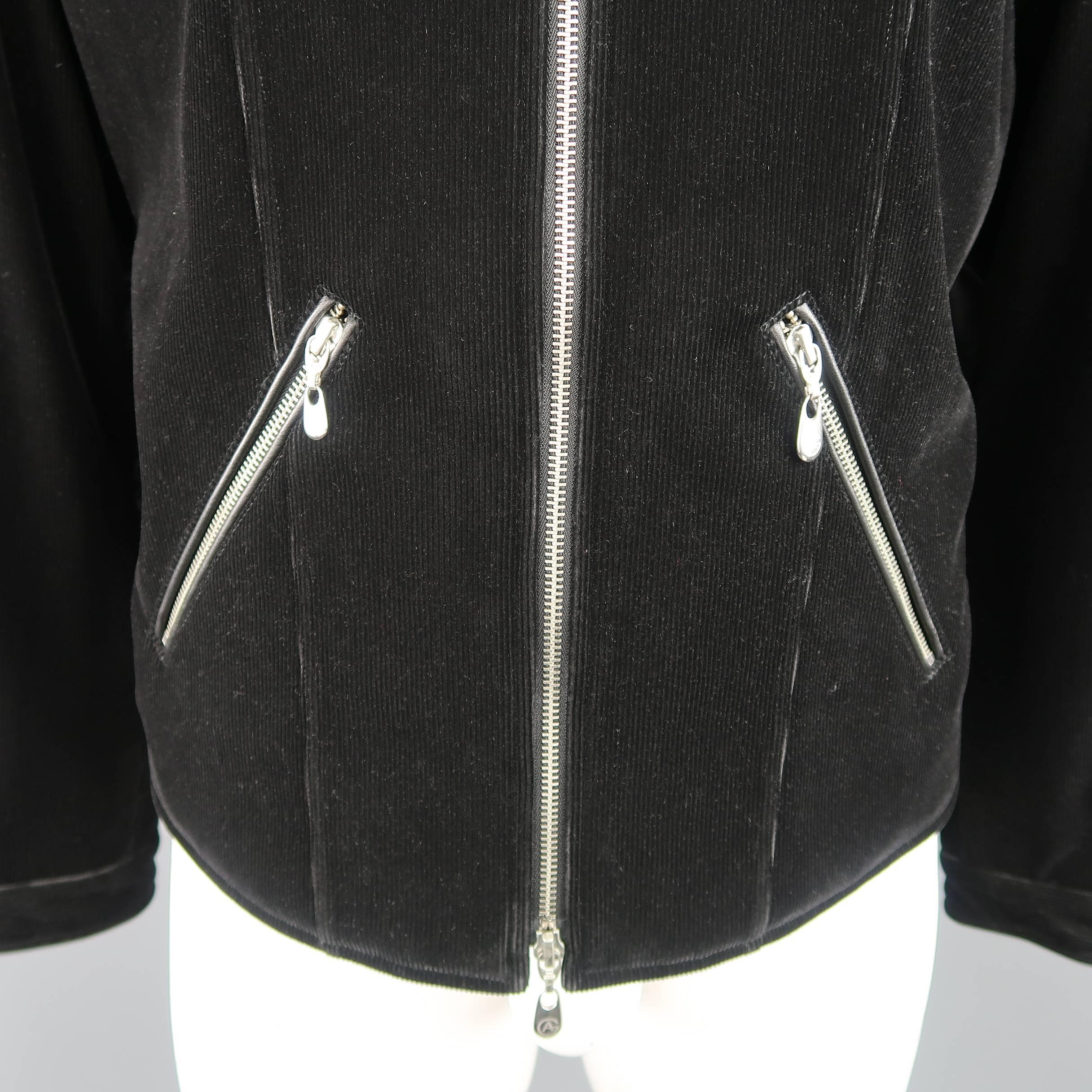 ARMANI COLLEZIONI biker motorcycle style jacket comes in black corduroy and features a band collar with snap, double zip front, diagonal zip pockets, black piping and elbow patches, and stretch back panel with tabs. Minor wear and missing zip tab.