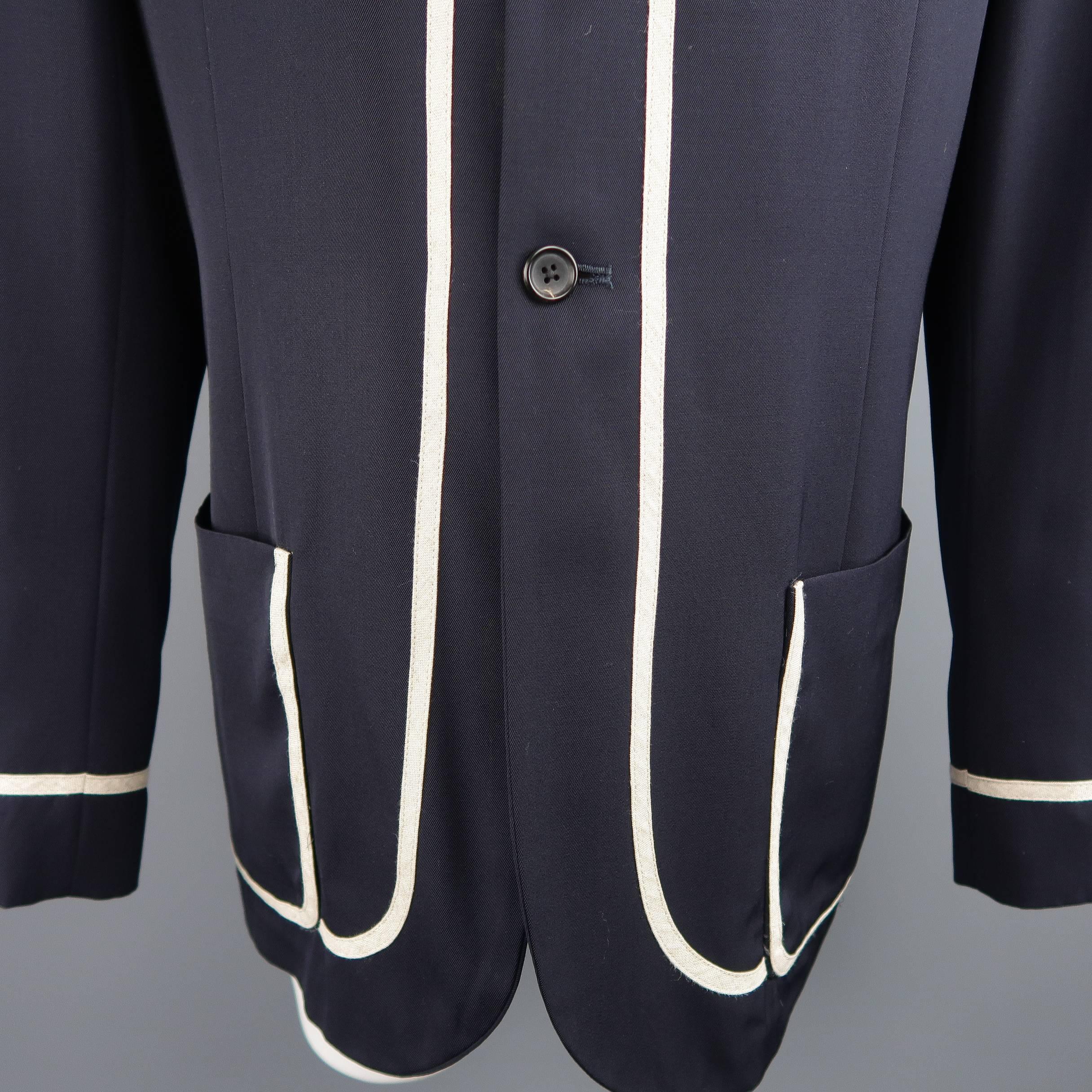Archive Yohyi Yamamoto pour Homme oversized sport coat comes in light weight navy wool twill and features a notch lapel, three button front, patch pockets, and thick beige piping throughout. Made in Japan.
 
Good Pre-Owned Condition.
Marked: M
