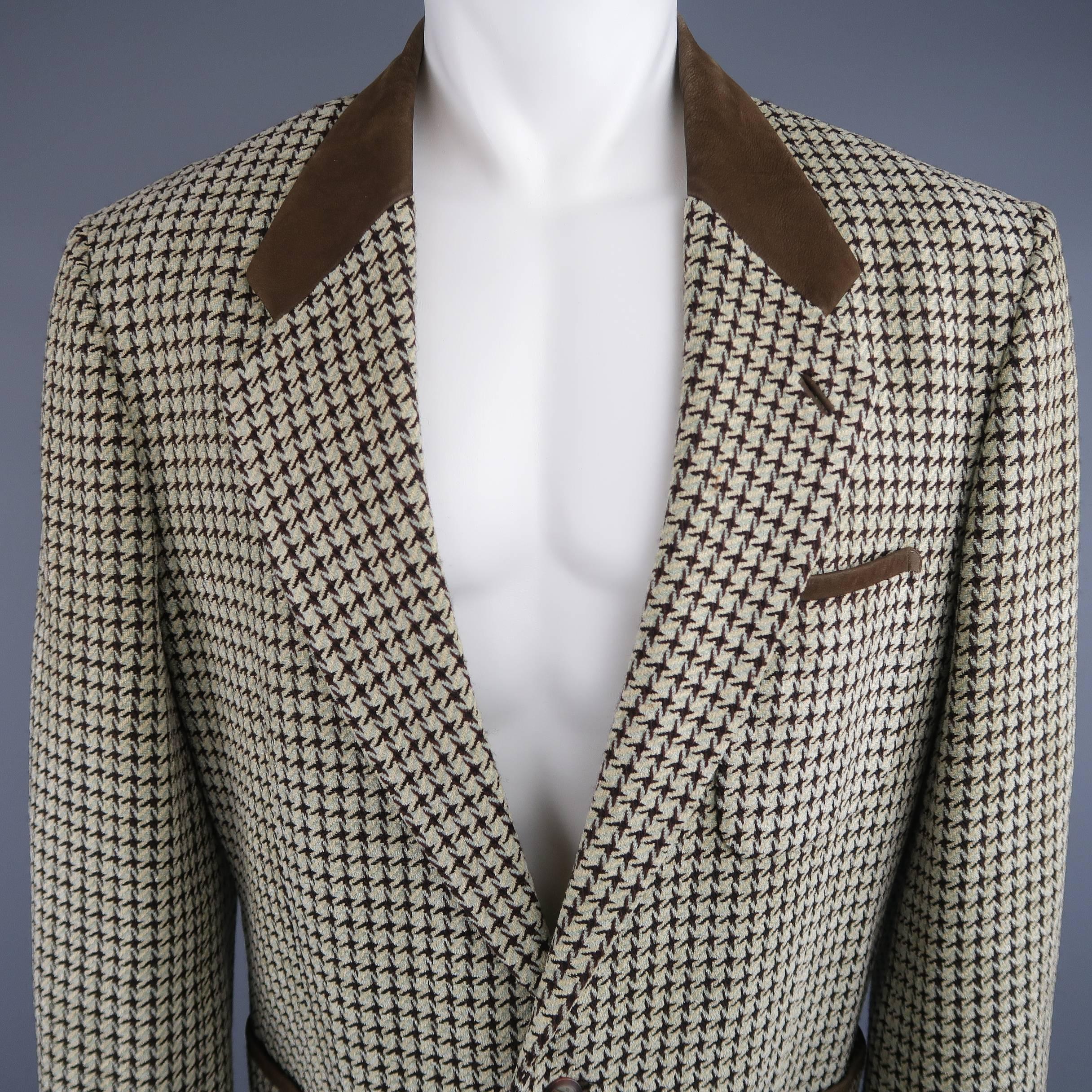 Vintage MATSUDA sport coat comes in muted mint green, beige, and chocolate brown houndstooth print wool and features a notch lapel with brown leather collar, two button closure, and patch pockets with leather trim. Made in Japan.
 
Good Pre-Owned