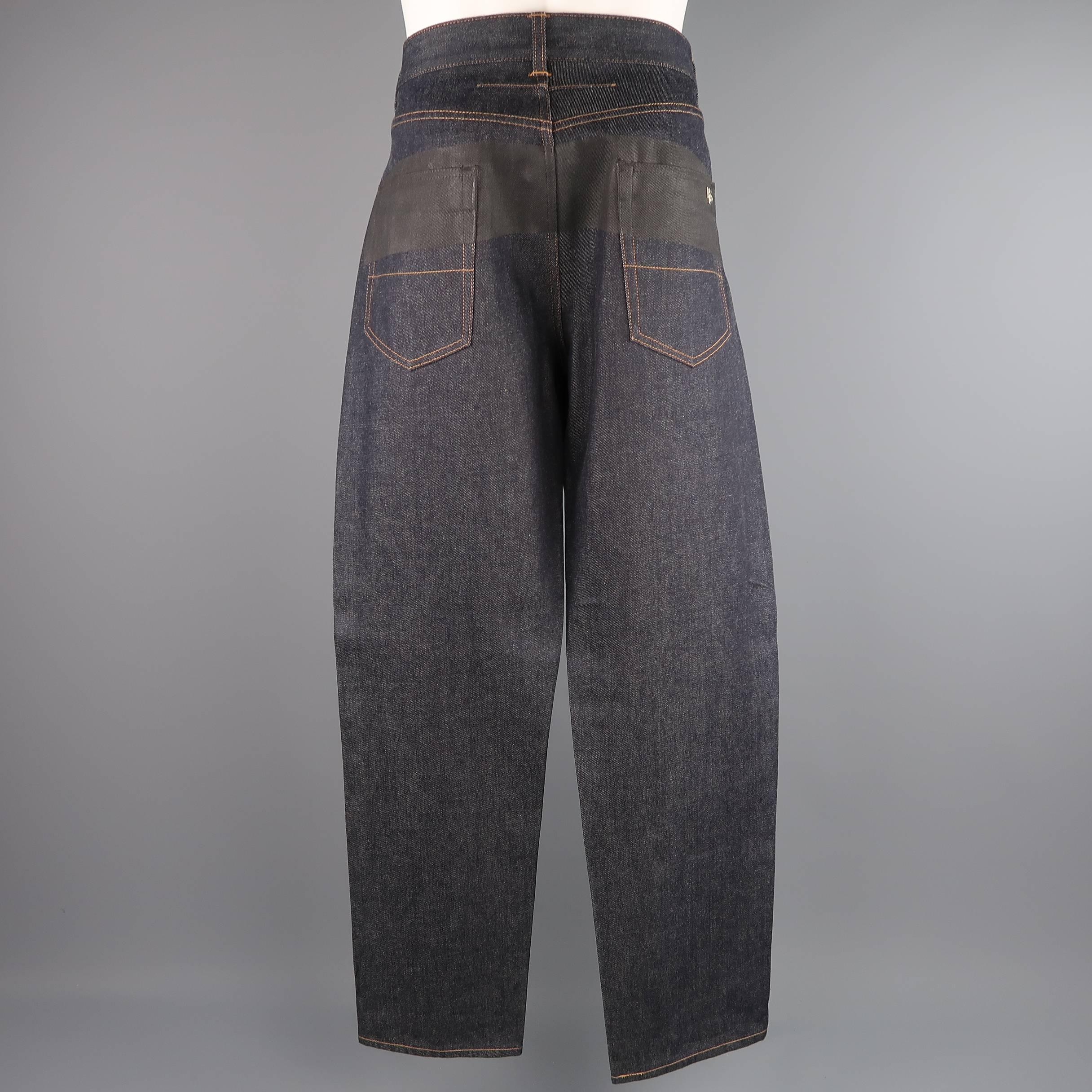 GIVENCHY by Riccardo Tisci jeans come in dark raw denim and feature a classic rise, loose relaxed fit, tan contrast stitching, silver tone metal HDG 