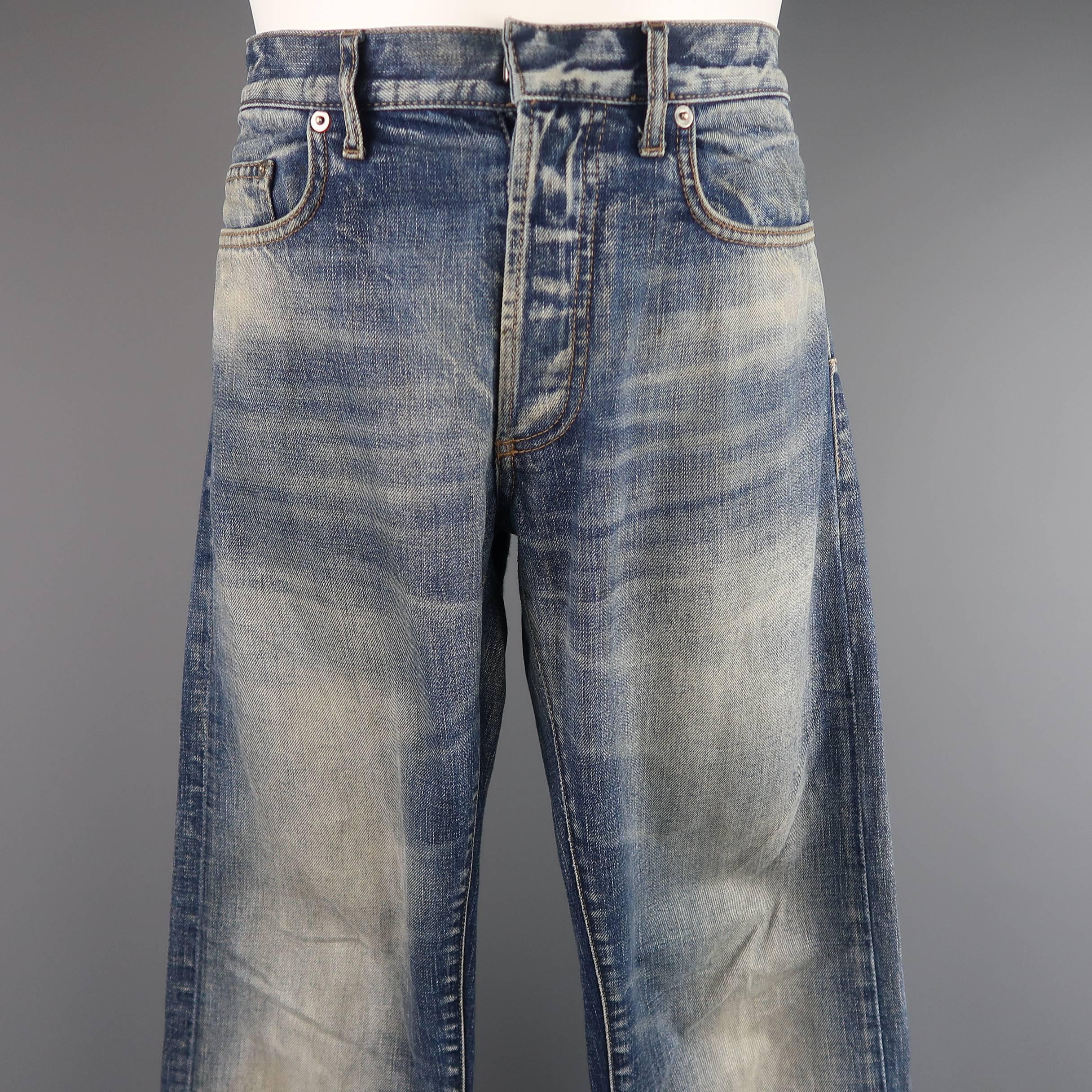 DIOR HOMME by Hedi Slimane skinny jeans come in a medium blue dirty wash denim with a button fly, signature back darts, and distressed details throughout. Minor wear. hem coming undone on one leg. As-Is. Made in Japan.
 
Good Pre-Owned