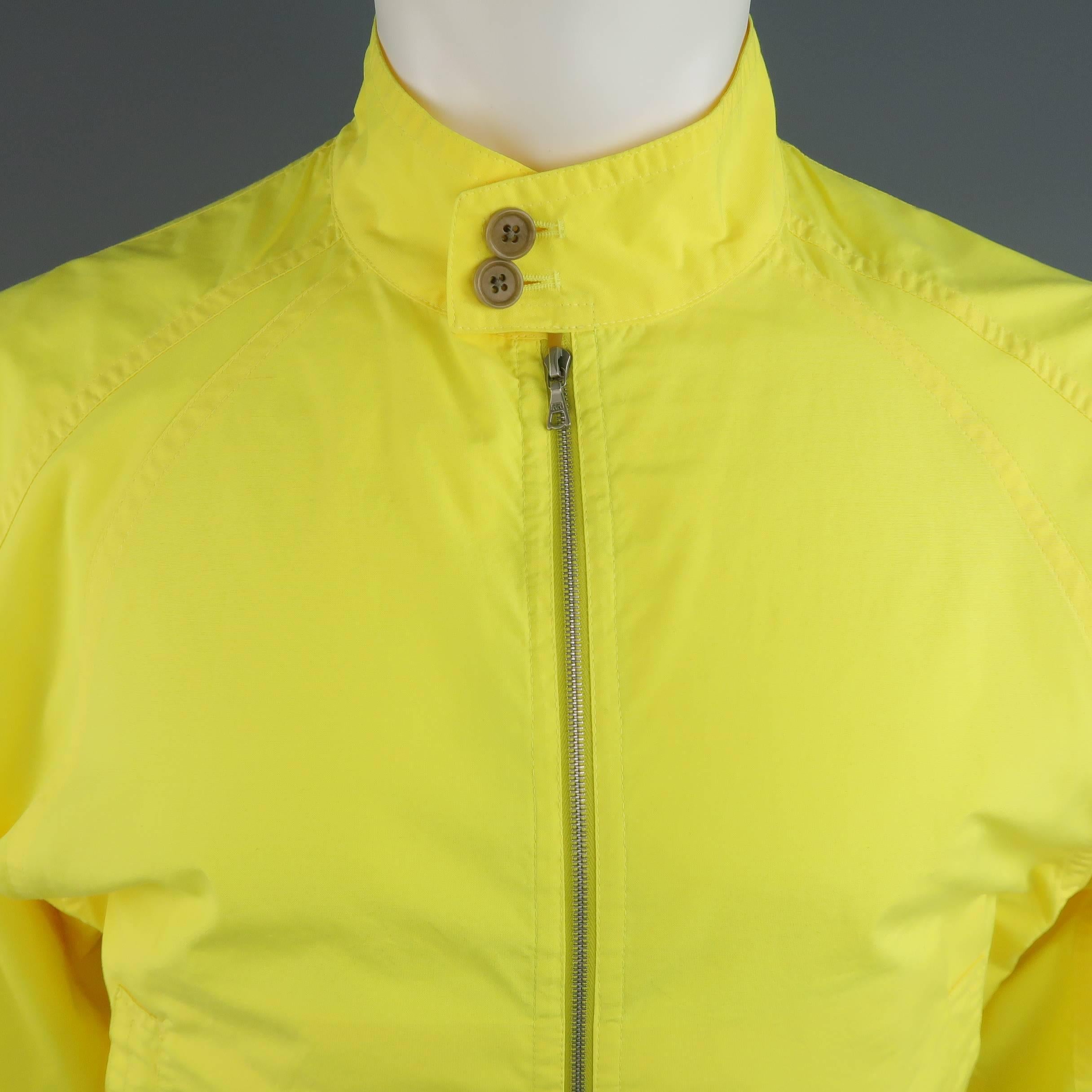 DRIES VAN NOTEN bomber jacket comes in a bold yellow cotton blend canvas and features a high, button over collar, double zip front, slit pockets, elastic cuffs, and raglan sleeves.
 
Excellent Pre-Owned Condition.
Marked: Small
 
Measurements:
