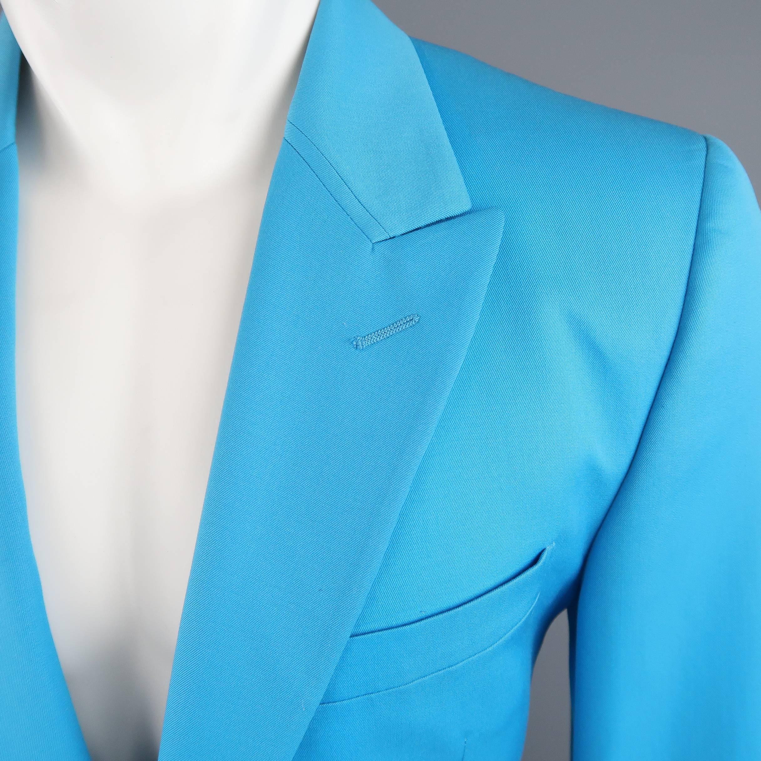 Vintage 1990's GIANNI VERSACE Couture sport coat comes in bold electric blue wool twill and features a peak lapel, single button front, flap pockets, and satin Medusa liner. Minor wear throughout fabric including spots shown in detail shots. As-Is.