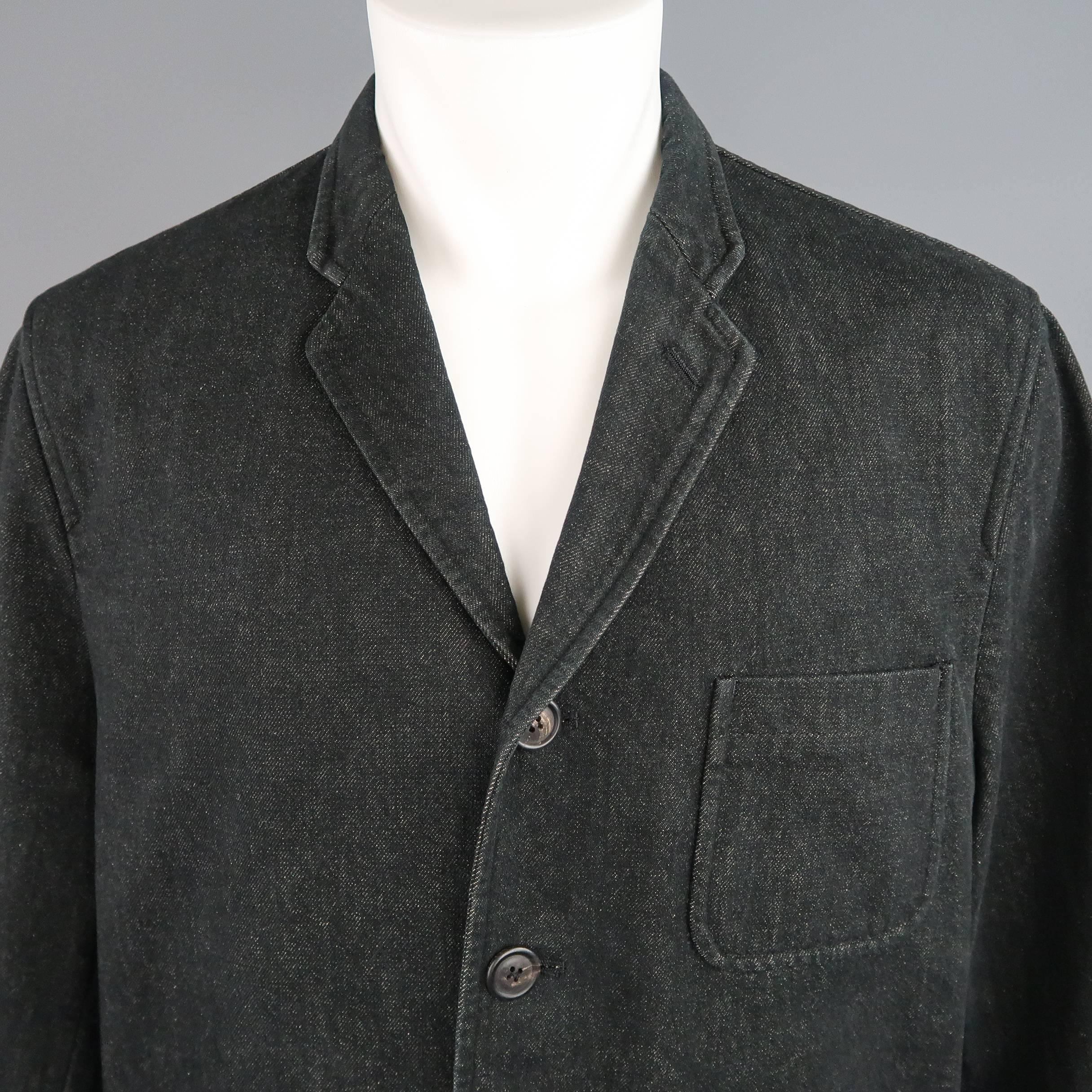 Vintage 1992 Comme des Garcons jacket comes in black raw denim and features a notch lapel, four button front, patch pockets, and baseball jacket sleeves with ribbed cuffs. Made in Japan.
 
Good Pre-Owned Condition.
Marked: M (AD1992)
