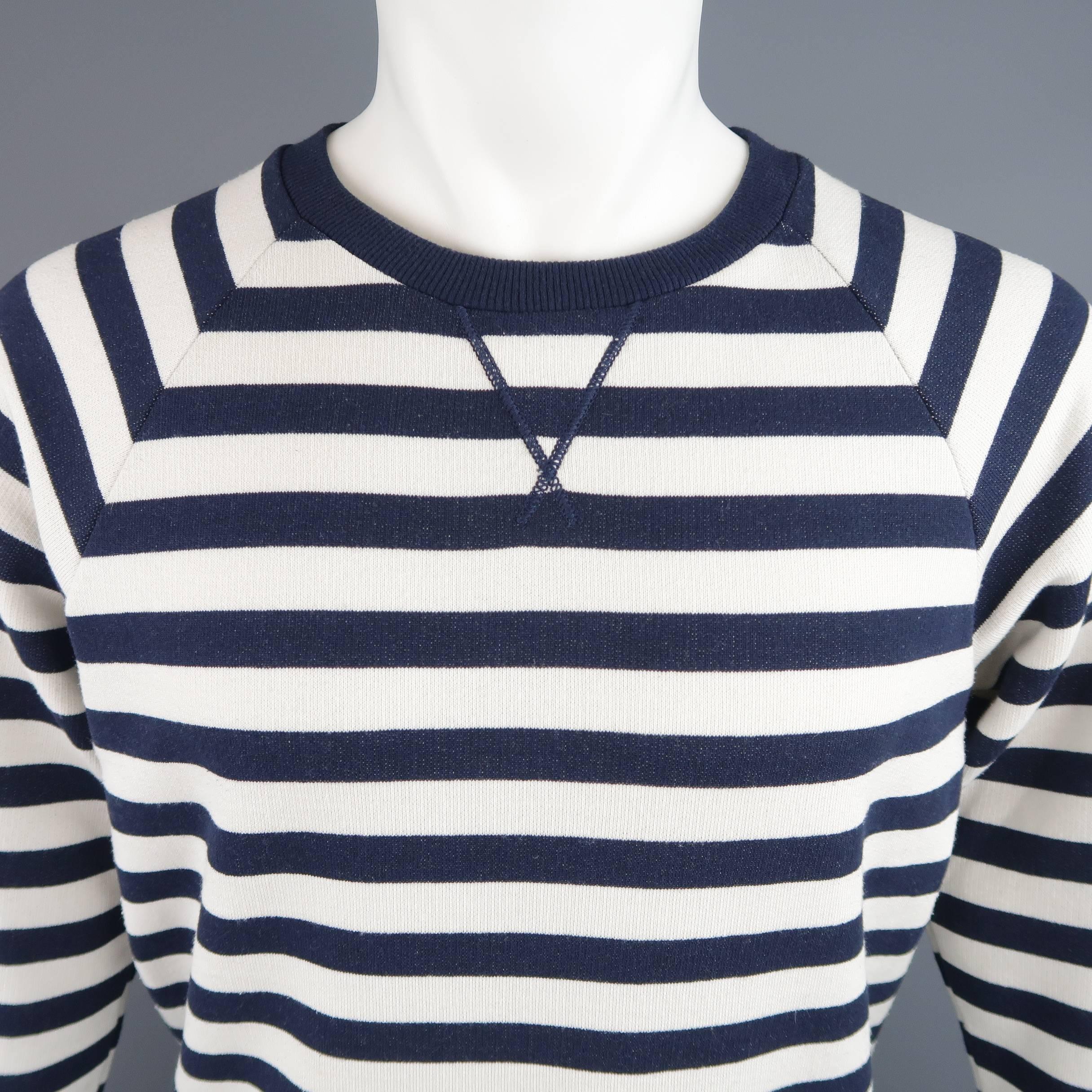 SAINT LAURENT pullover comes in cream and navy striped French terrycloth and features a round neck with dorito stitch, raglan sleeves, and ribbed cuffs.  Made in Italy.
 
Good Pre-Owned Condition.
Marked:  L
 
Measurements:
 
Shoulder: 16 in.
Chest: