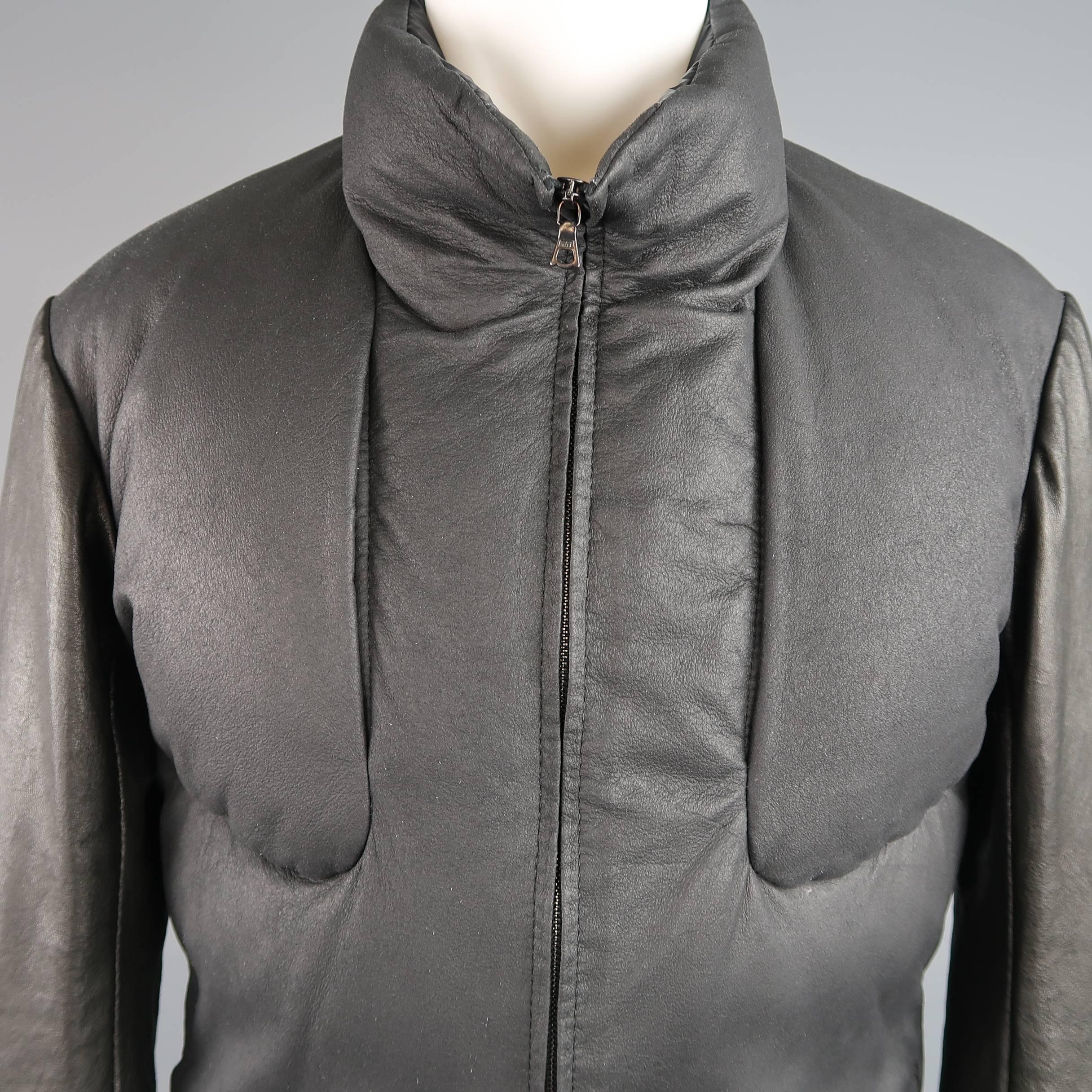 ISAAC SELLAM bomber jacket features a high collar, down filled deerskin textured leather body with chest pockets, and lamb skin leather sleeves with dark gold tone closure cuffs and grey knit glove liner. Made in France.
 
Good Pre-Owned