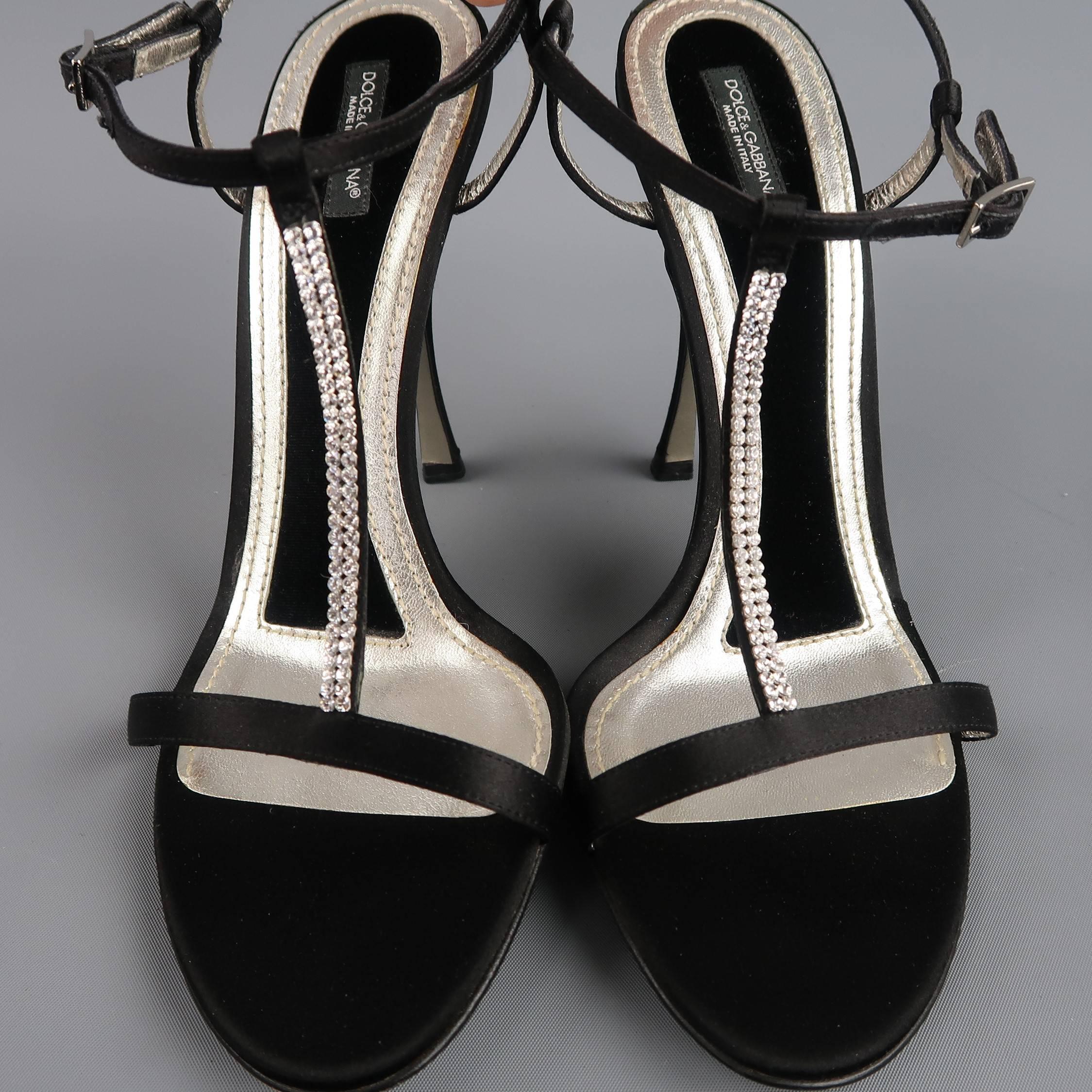 These fabulous DOLCE & GABBANA evening sandals feature a black silk satin & silver metallic leather sole with velvet padding, silk covered stiletto heel, skinny toe strap, ankle harness, and rhinestone studded T strap. Made in Italy.
 
Good