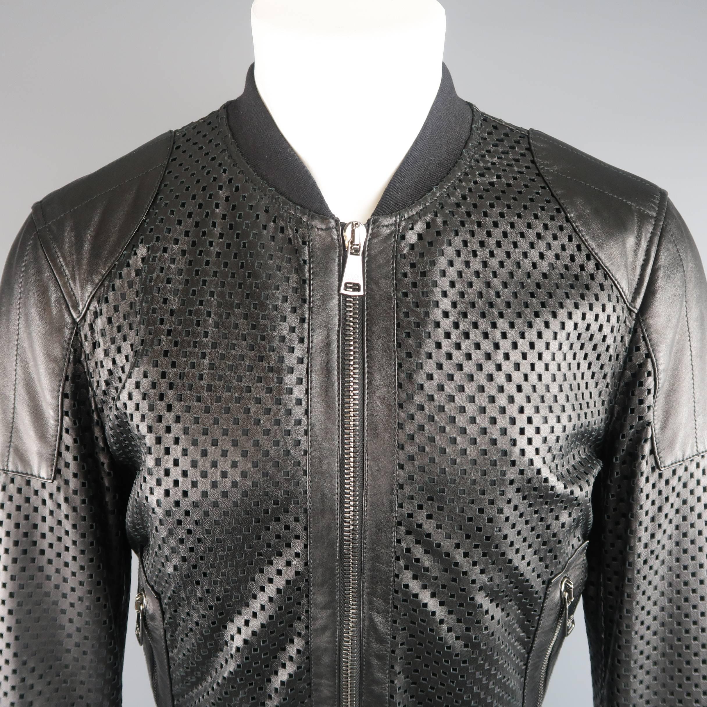 DOLCE & GABBANA baseball jacket comes in a checkered pattern perforated leather with a ribbed baseball collar, zip pockets, and shoulder pad detail. Minor wear including a couple tears shown in detail shots. As-is. Made in Italy.
 
Fair
