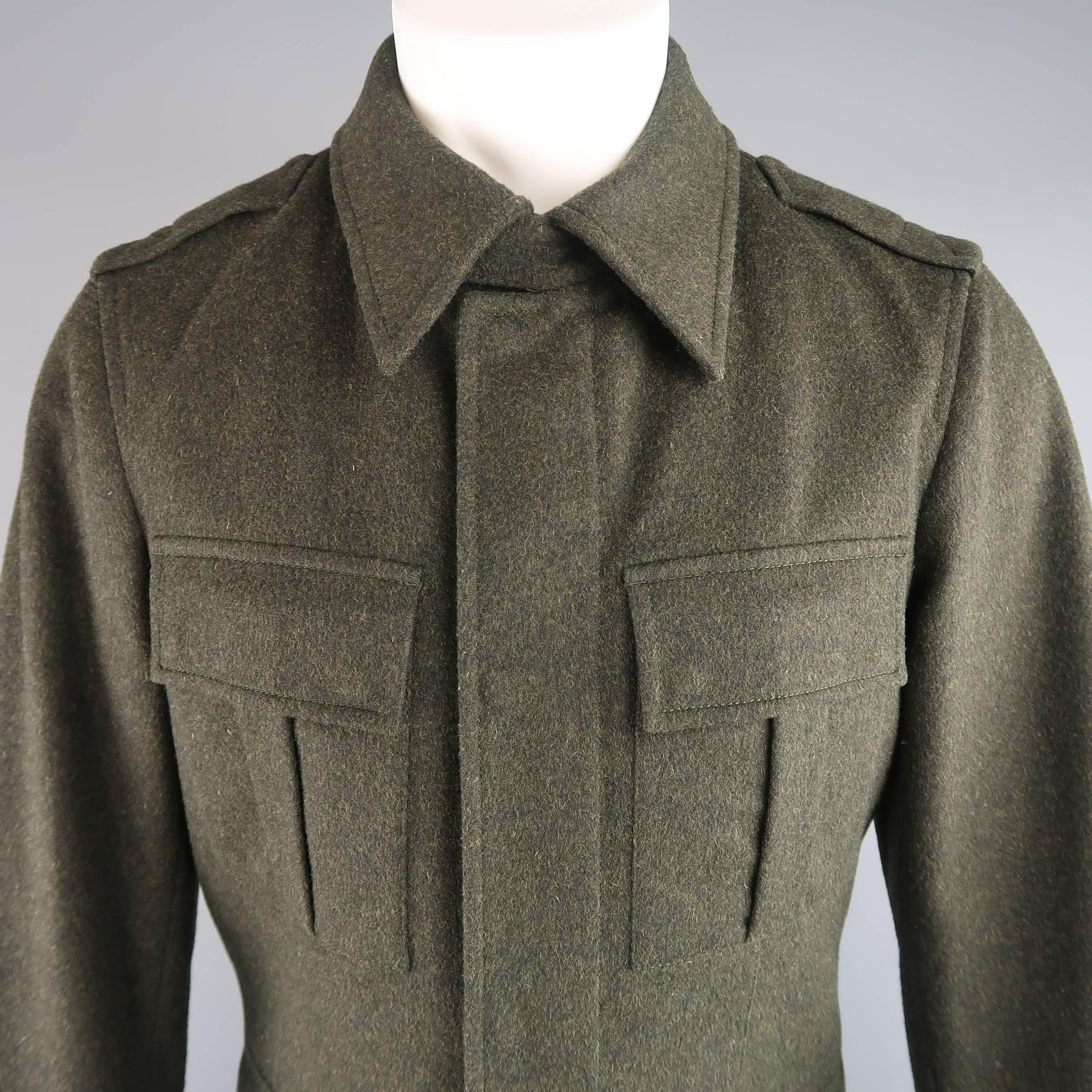 PRADA military style over coat comes in a heather textured green wool and features a pointed collar with snap tab, zip closure with hidden snap placket, patch flap pockets, epaulets, and nylon liner with extended cuffs. Care tags removed. As-Is.