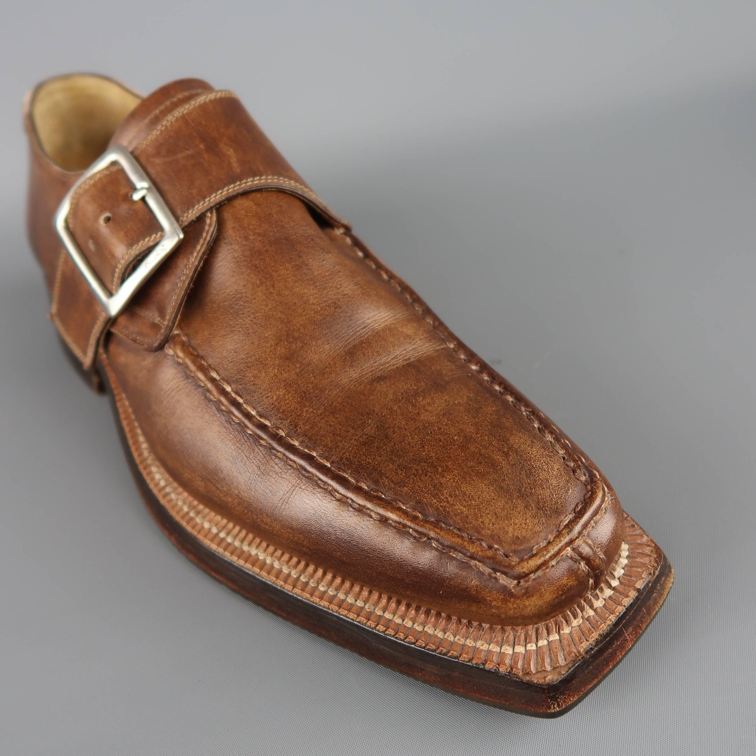 STEFANO BRANCHINI dress shoes come in a antique distressed tan leather and feature a squared split toe with apron top stitching, chunky outsole, and single monk strap with silver tone engraved buckle. Made in Italy.
 
Good Pre-Owned
