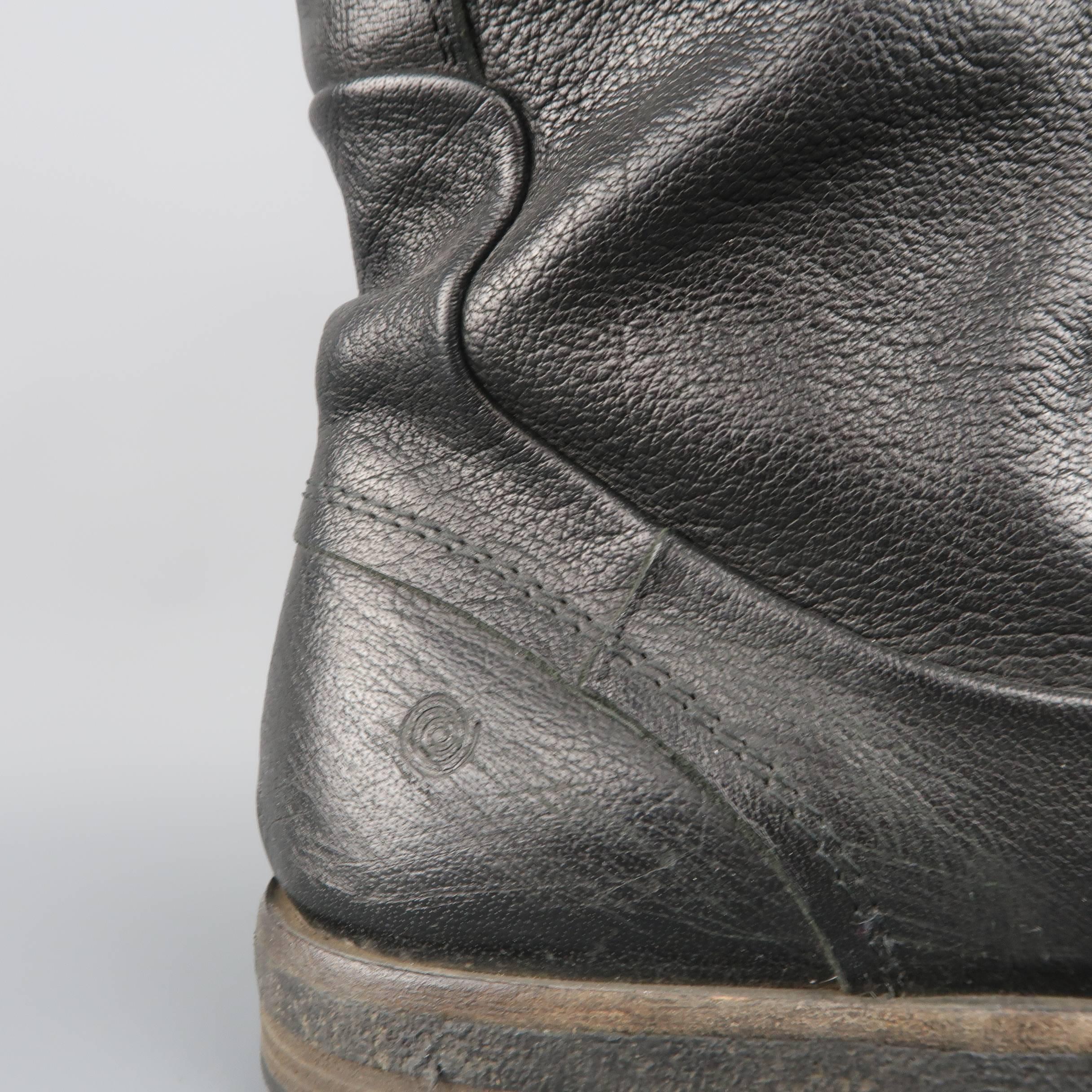 MARSELL biker style boots come in distressed black leather with a curved toe cap, crepe sole, internal zip, and knit shaft liner. Wear throughout. Made in Italy.
 
Fair Pre-Owned Condition.
Marked: (no size)
 
Outsole: 12 x 4.25 in.
Height: 10
