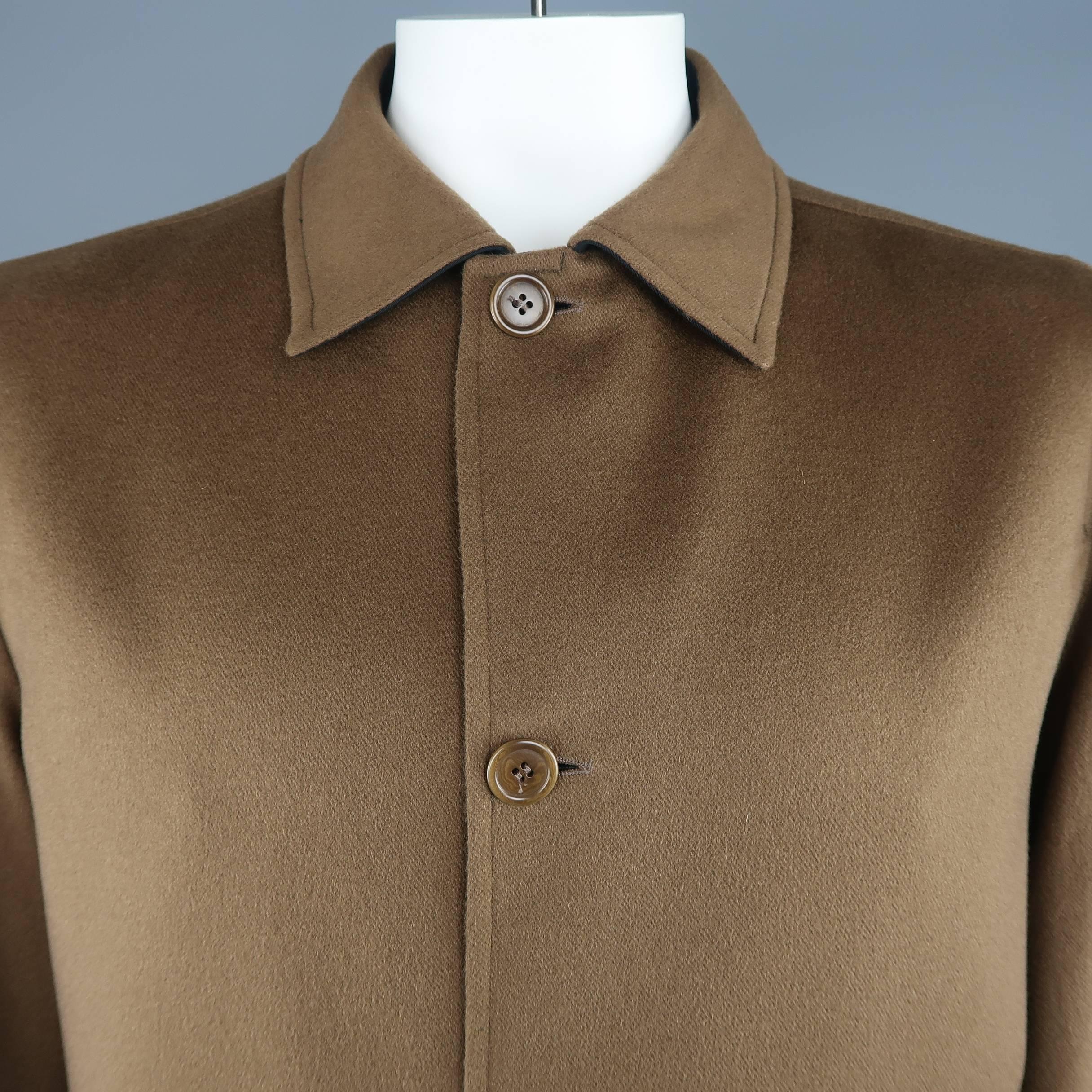 ERMENEGILDO ZEGNA car coat comes in light brown cashmere with a pointed collar, button up front, and patch pockets. Wear reverse in black twill. Made in Italy.
 
Excellent Pre-Owned Condition.
Marked: IT 50
 
Measurements:
 
Shoulder: 19 in.
Chest:
