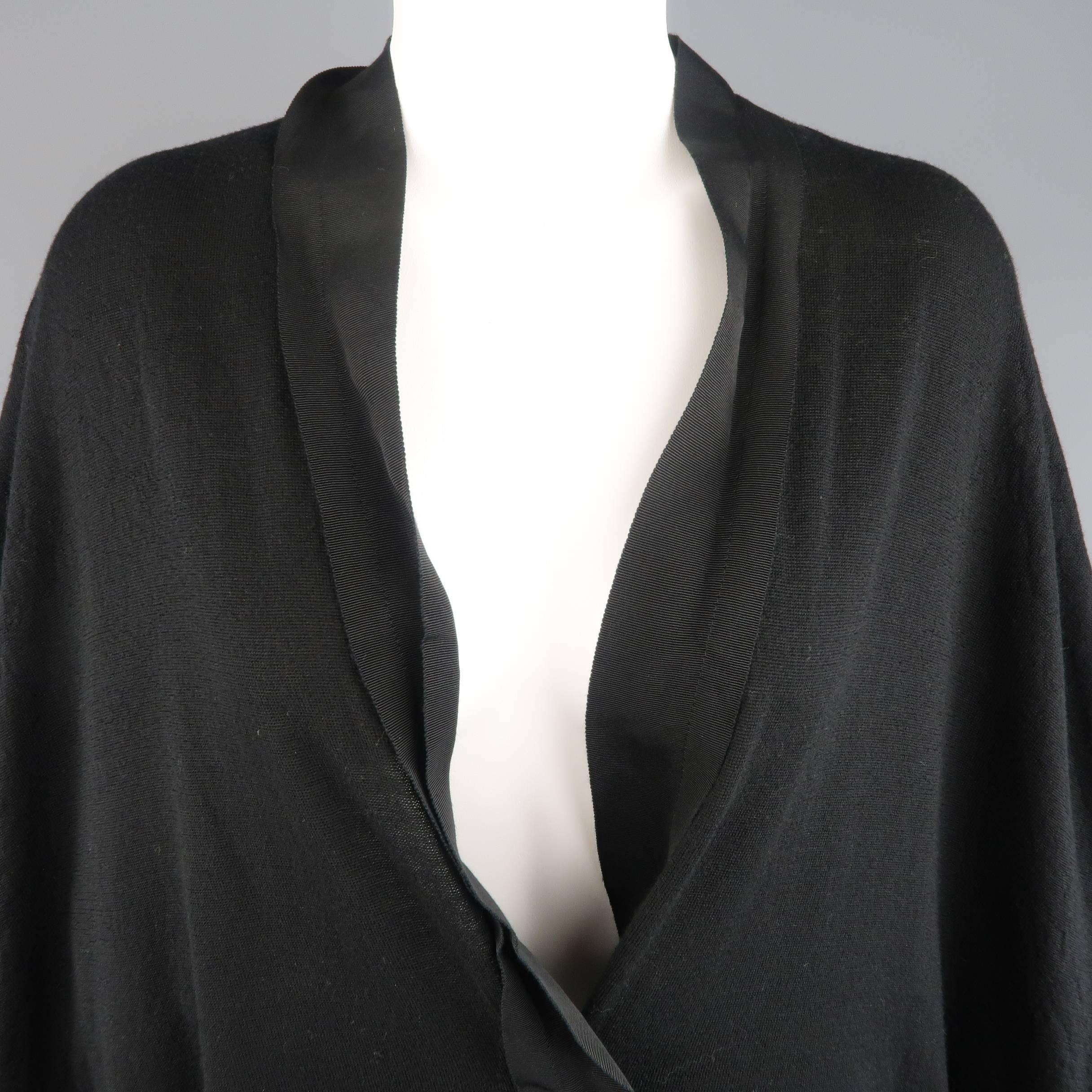 LANVIN cardigan comes in a light weight jersey knit and features a deep N neckline with single snap closure, ribbon piping, and batwing sleeves with textured details. Care tags removes. As-Is.
 
Good Pre-Owned Condition.
Marked: (no size)
