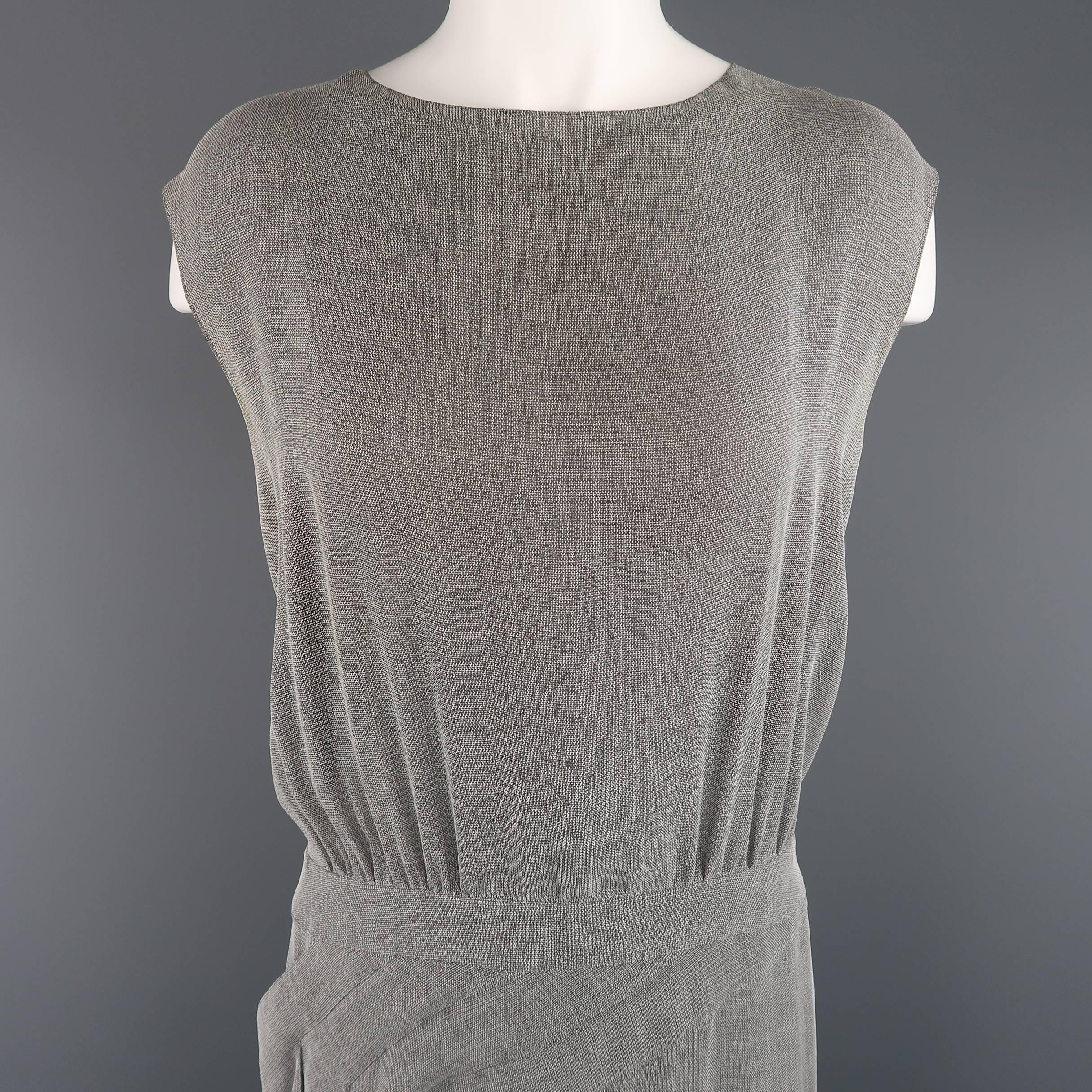 This archive CHANEL sleeveless shift dress from the Spring Summer 1999 collection comes in a light weight gray chainmail look mesh knit and features a round neckline, blousey gathered top, button up back with slit, drop waist, and A line skirt with