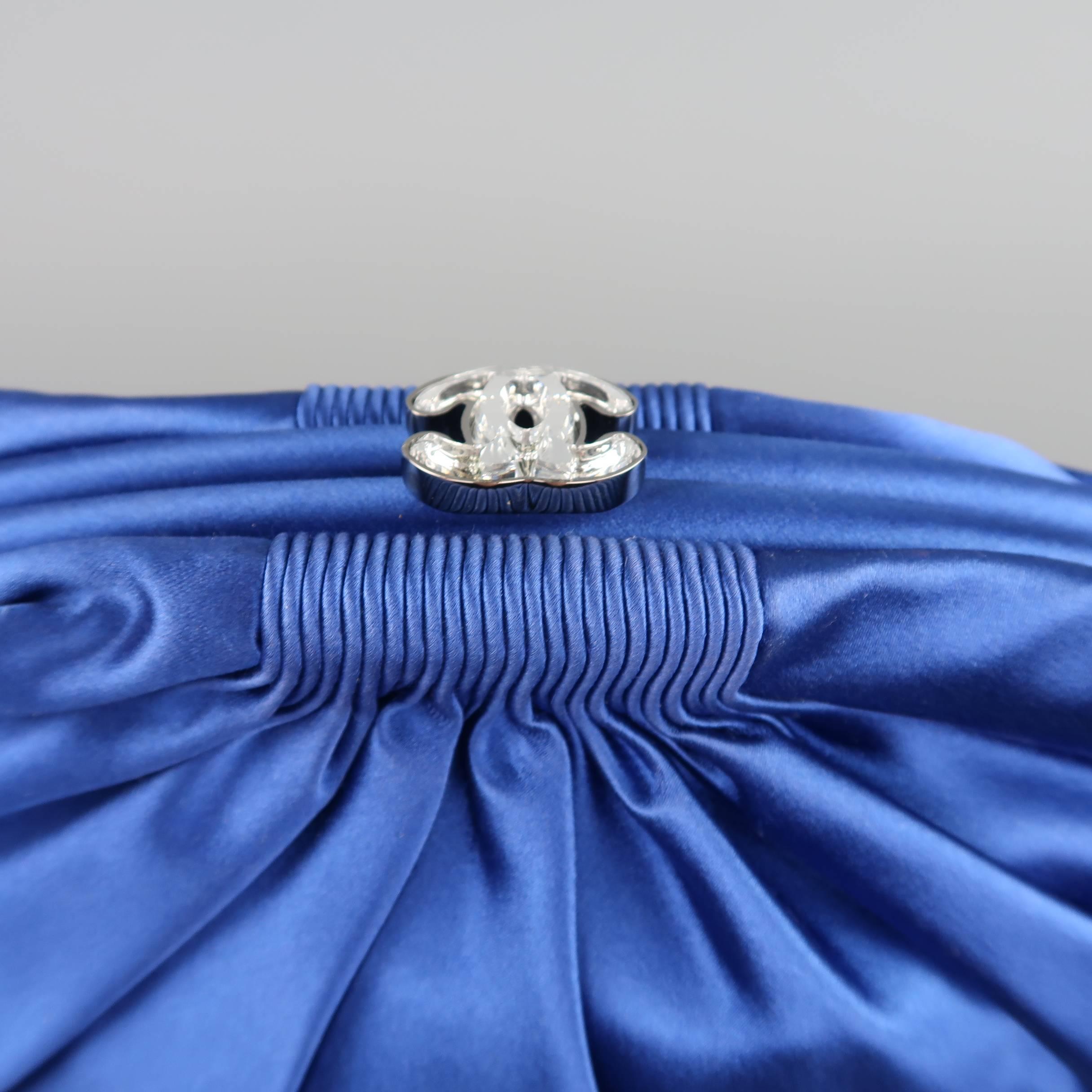 Gorgeous CHANEL evening clutch comes in sapphire blue silk satin and features a pleated construction and a clasp lock closure with clear crystal CC logo embellishment. Made in Italy.

Retails at: $2,150.00
Good Pre-Owned Condition.
Marked: 1372677

