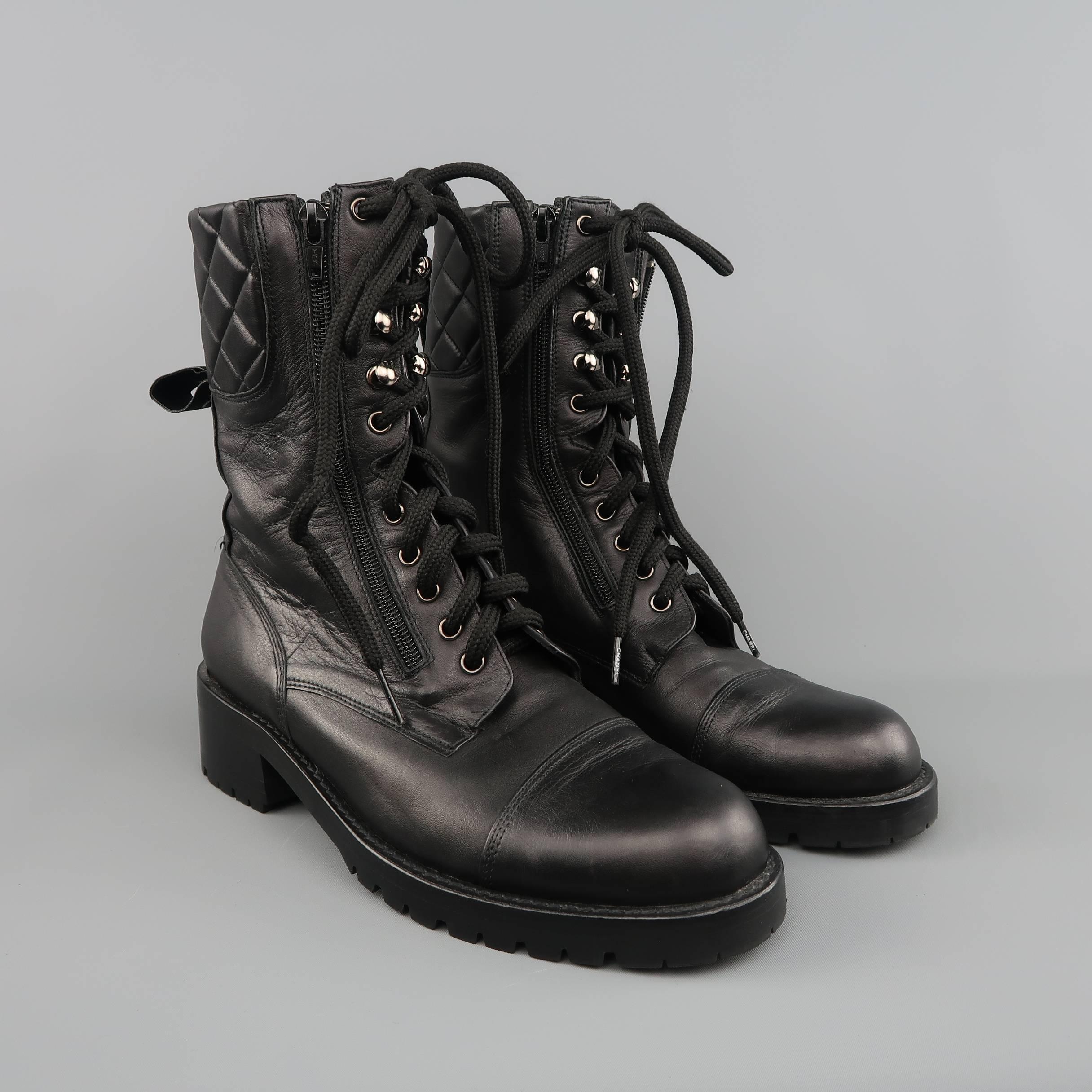 CHANEL combat style boots come in black smooth leather and feature a cap toe, lace up front with grommets and hooks, double zip closure, logo embossed tongue, quilted ankle, heeled commando sole, and logo back tabs. Made in Spain.
 
Excellent