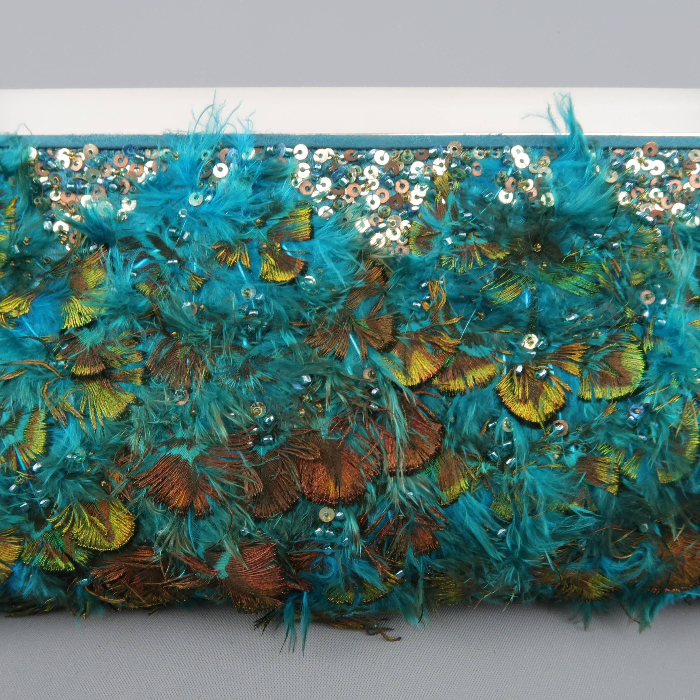 This fabulous Judith Leiber evening clutch comes in a vibrant teal green silk satin completely embellished with peacock feather and sequins with a matte lucite handle detailed with blue and white art deco style crystal adornments, optional silver