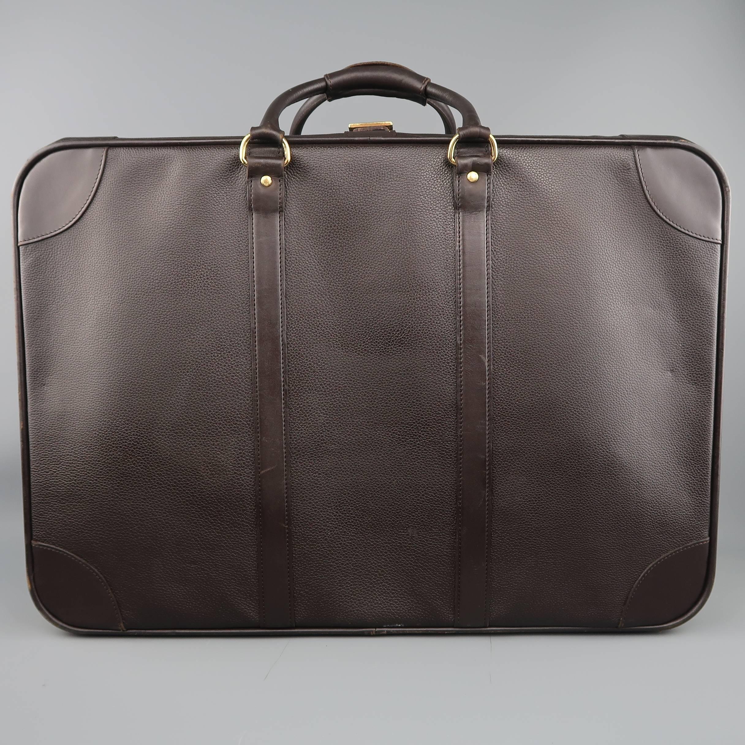 Vintage LONGCHAMP suitcase travel bag comes in chocolate brown pebbled leather in a large rectangular box shape with covered snap tab top handles and zip closure with buckle. Wear throughout. As-Is. Made in France.
 
Fair Pre-Owned Condition.
