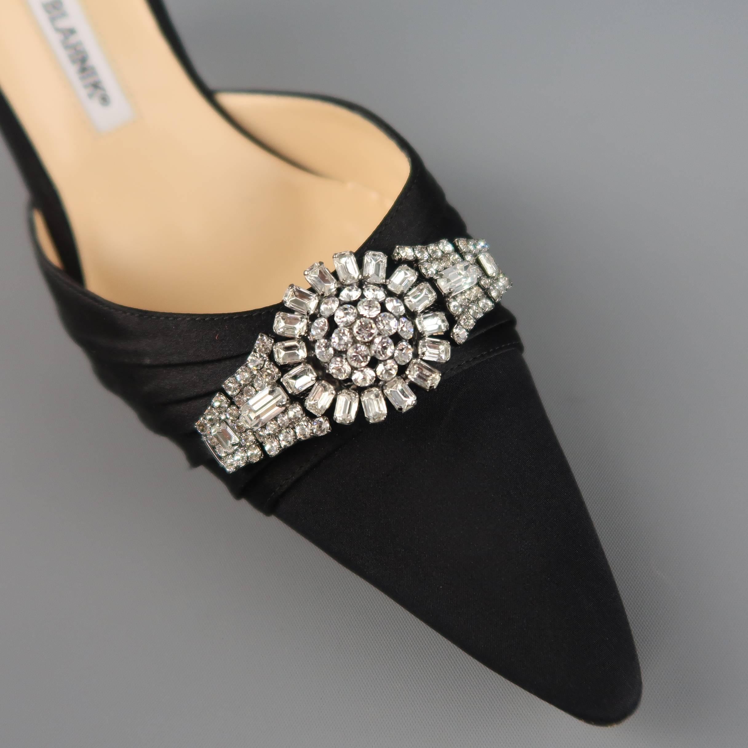 These fabulous MANOLO BLAHNIK evening pumps come in black silk covered leather and feature a D'orsay cut, covered stiletto heel, and pointed toe with pleated satin and rhinestone adornment. Made in Italy.
 
New with Tag.
Marked: IT 40.5
 
Heel: 3