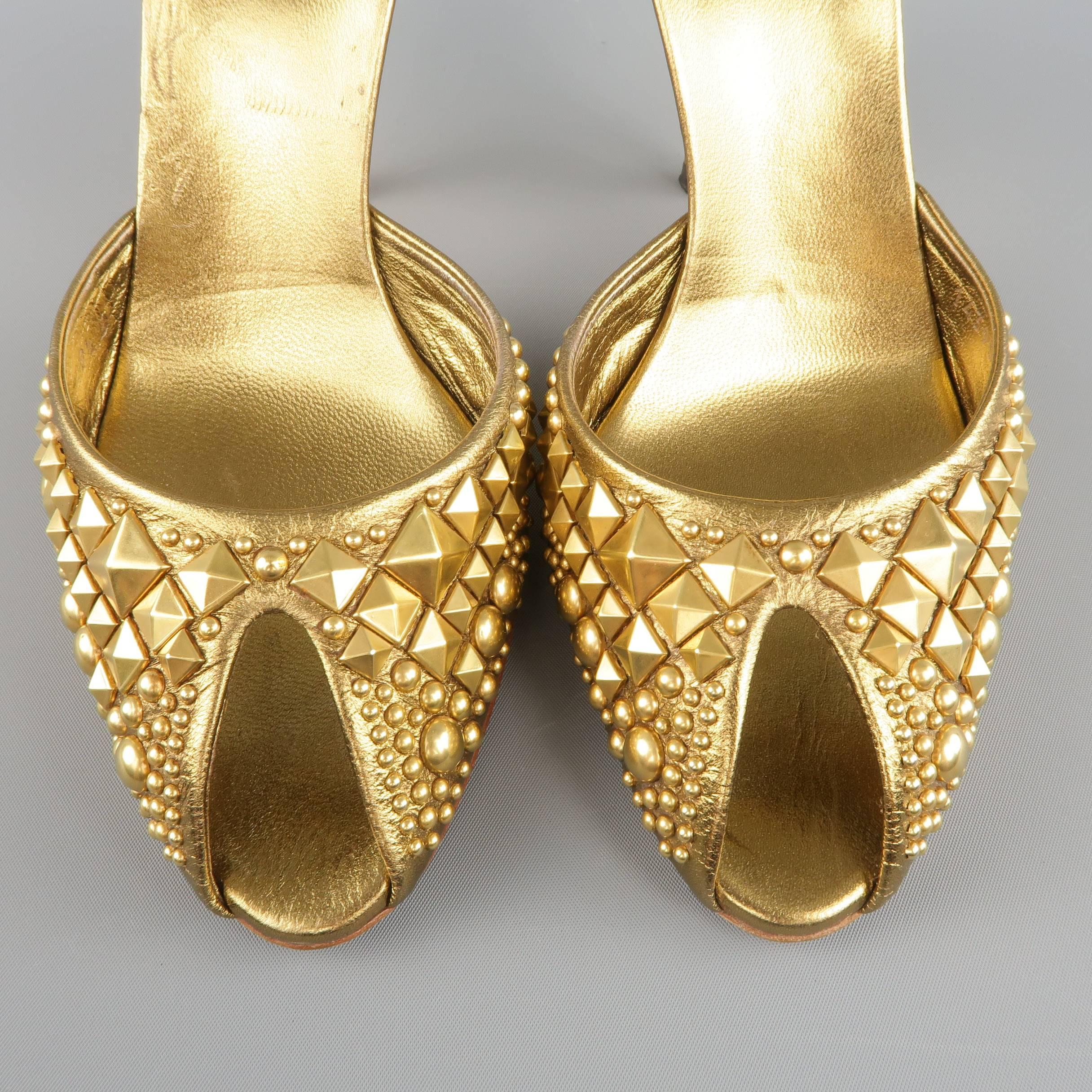 These fabulous GUCCI mules come in metallic gold leather and features a slit peep toe with all over pyramid and dome stud embellishments and chunky studded stiletto heel. Made in Italy.
 
Excellent Pre-Owned Condition.
Marked: 9.5 B
 
Heel: 4.75