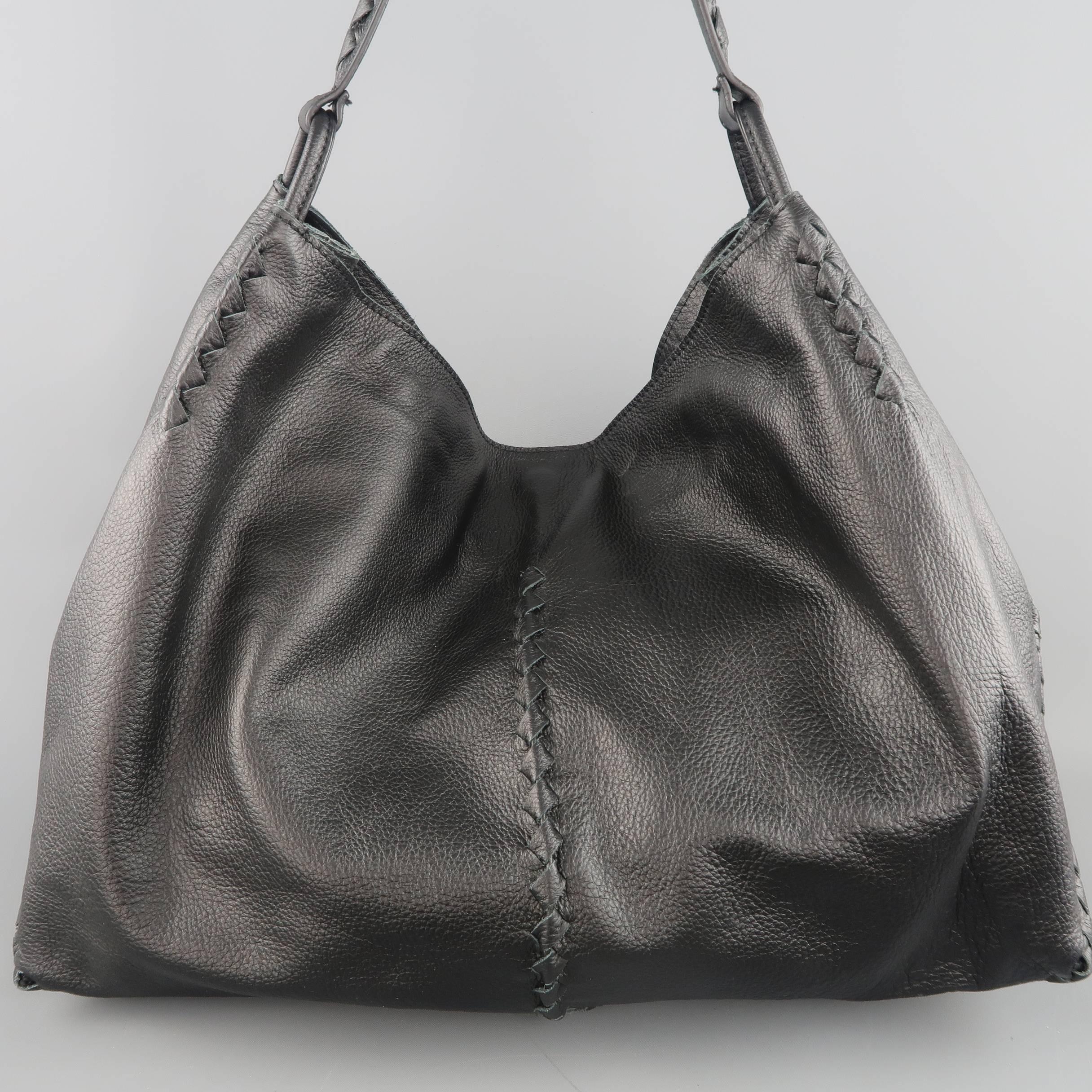 BOTTEGA VENETA hobo shoulder bag comes in black textured deer skin leather and features signature intrecciato woven piping, square angle corners, magnet closure, and woven shoulder strap. Made in Italy.
 
Retails at $2,050.00
Excellent Pre-Owned