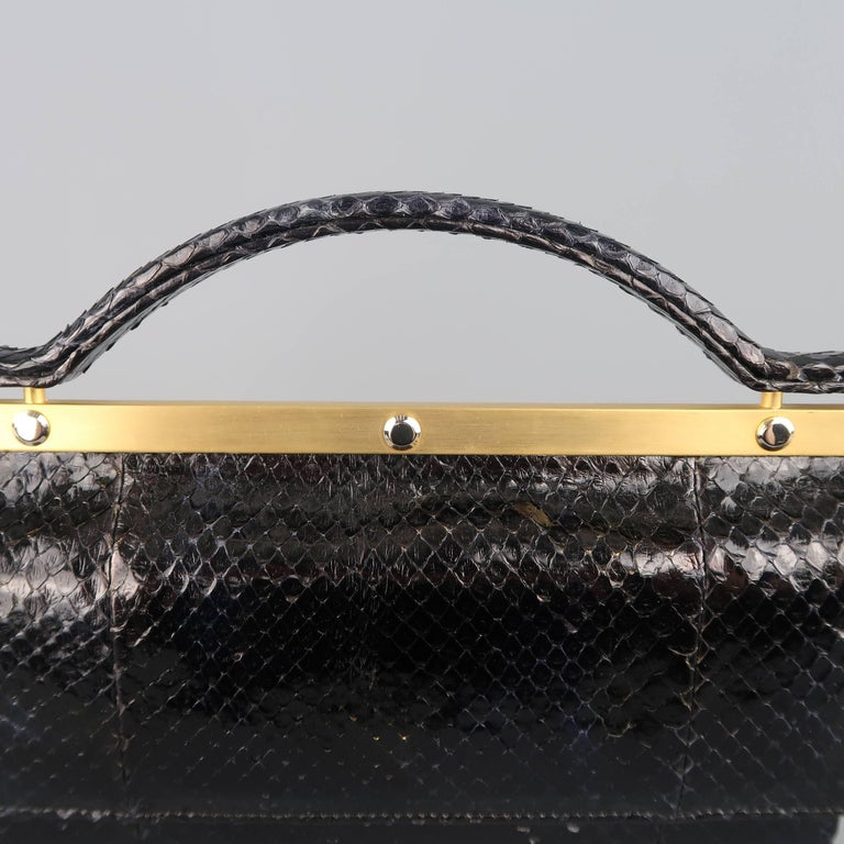 Vintage Leu Locati evening purse comes in black snakeskin leather and features dual flap snap pockets, gold leather liner, gold tone metal top bar and covered top handle. Minor wear on corners. Made in Italy.
 
Good Pre-Owned Condition.
