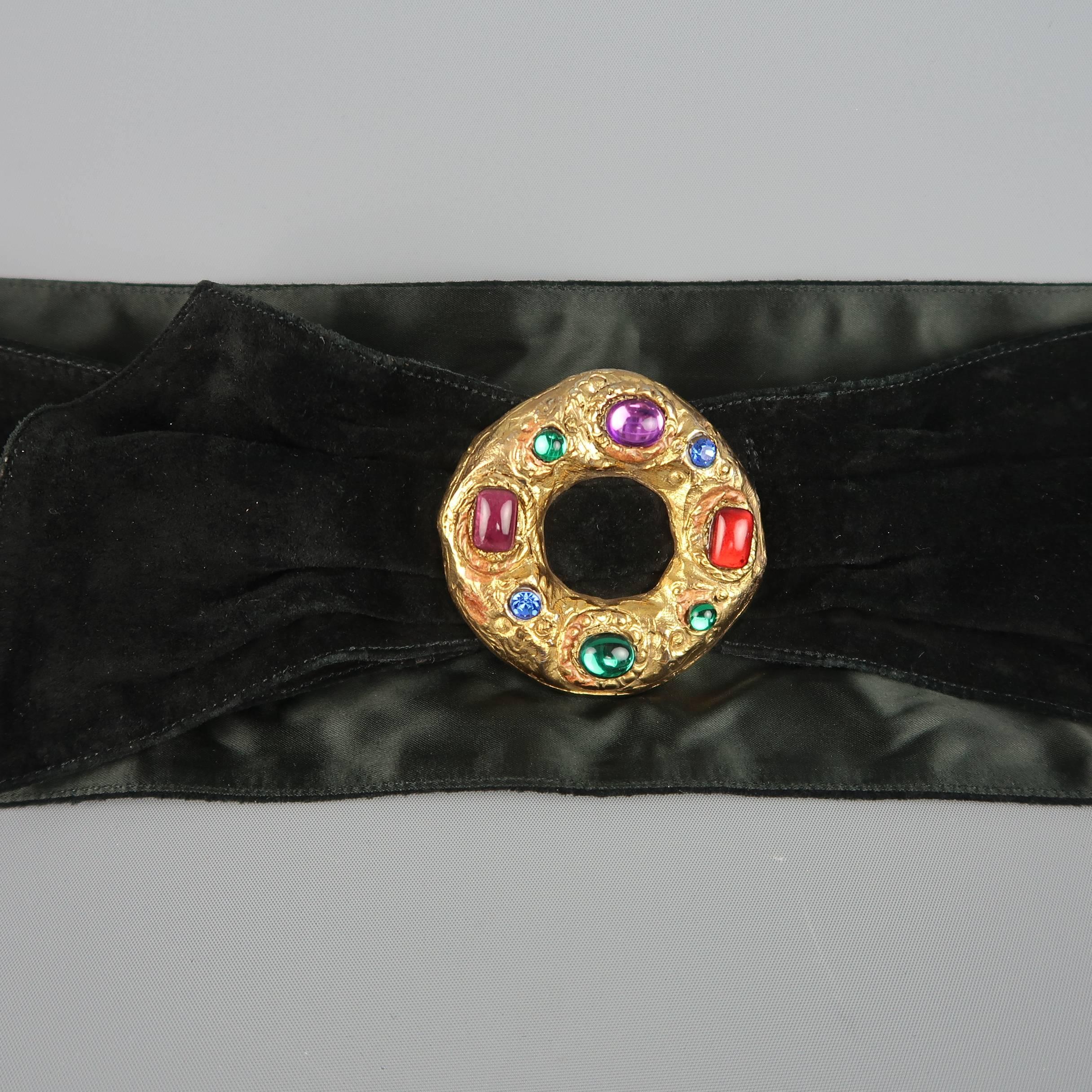 Vintage 1980's UNGARO belt features a gathered suede sash, gold tone Byzantine style hoop brooch with muti-color faux crystals, and velcro closure. Wear on brooch. As-is. Made in France.
 
Good Pre-Owned Condition.
Marked: EU 42
 
Length: 36