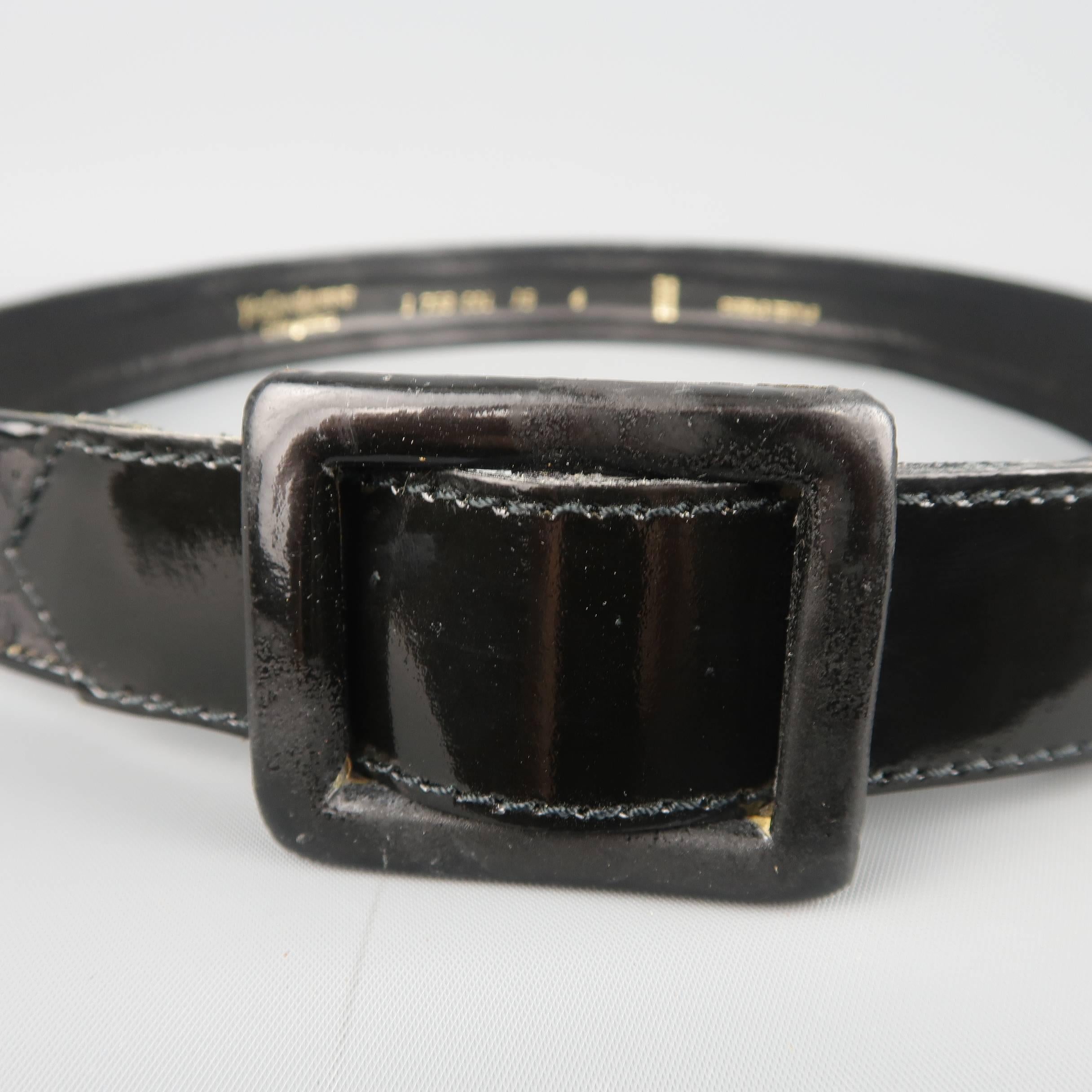 Vintage YVES SAINT LAURENT Rive Gauche belt features a  black sequin patent leather strap with leather square buckle. Minor wear. Made in France.
 
Good Pre-Owned Condition.
Marked: 1 753 COL 15 4
 
Length: 35 in.
Width: 1.25 in.
Fits: 33 in.

SKU: