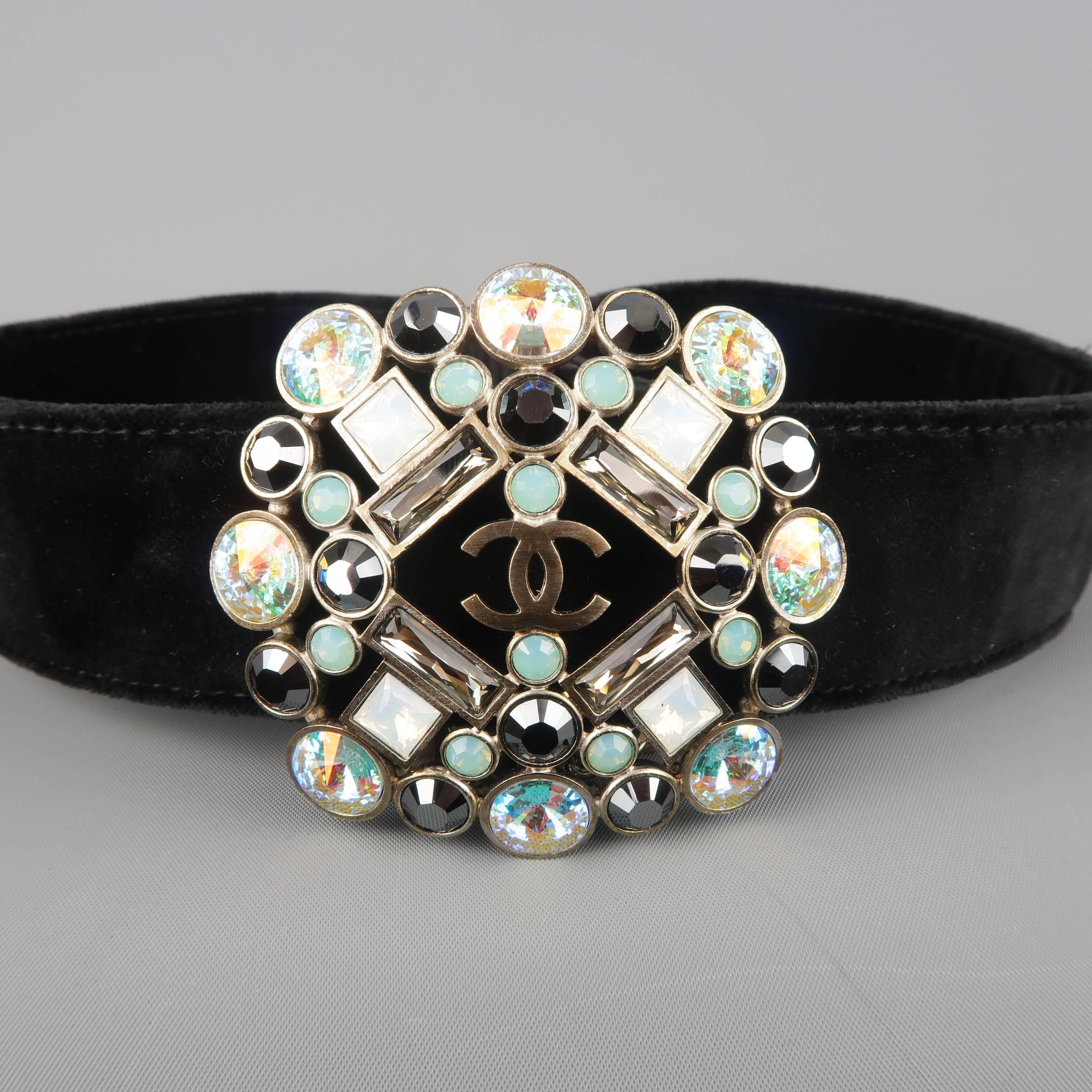 This gorgeous CHANEL statement belt from Fall Winter 2006 Collection features a black velvet strap, chain clasp closure with charm, and oversized Aurora Borealis crystal Gripoix CC brooch motif. Made in France.
 
Good Pre-Owned Condition.
Marked: