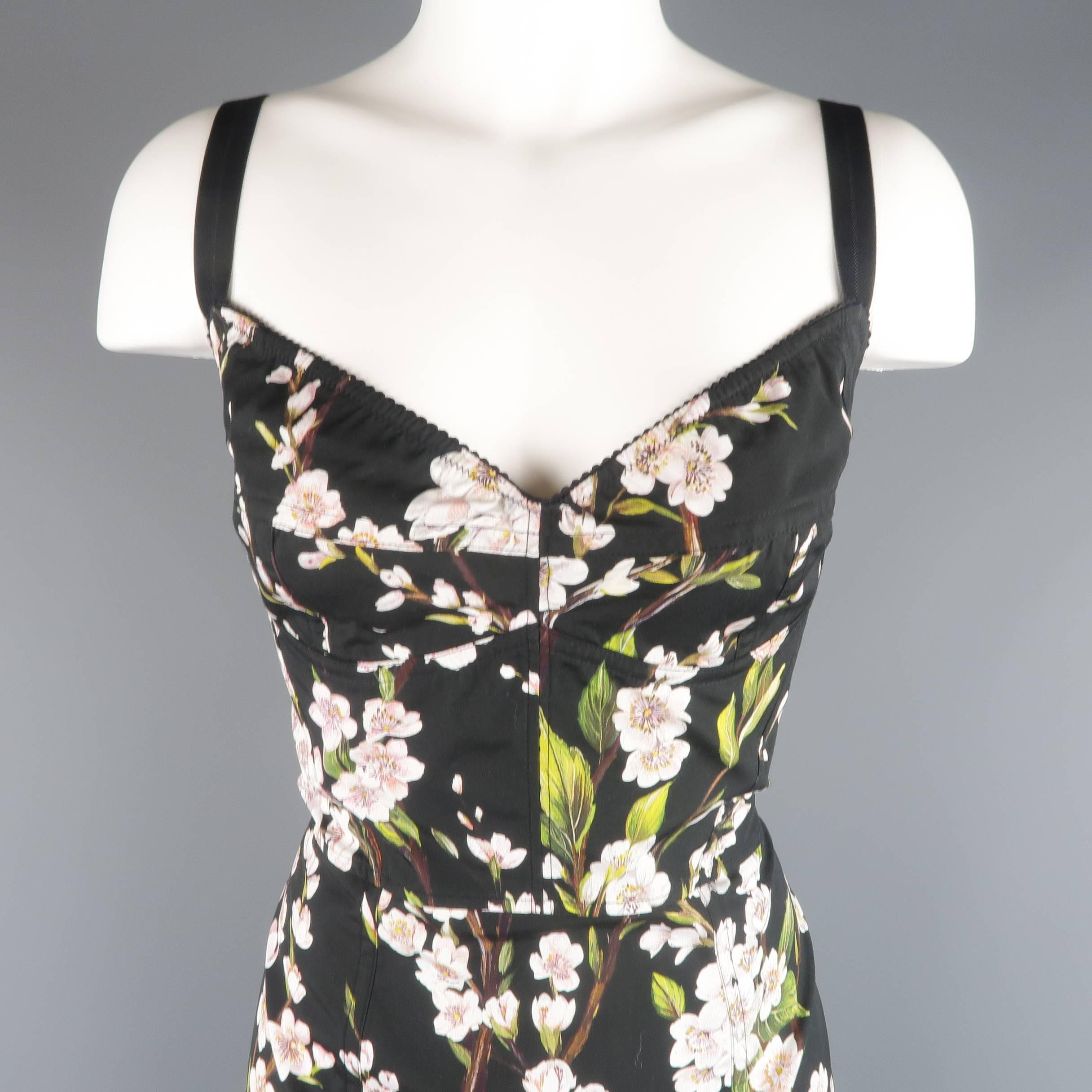 DOLCE & GABBANA sheath dress comes in a light weight black cotton with all over cherry blossom print and features a retro lingerie constructed bustier bra bodice top, fitted pencil skirt, and stretch panel back. Made in Italy.
 
Excellent Pre-Owned