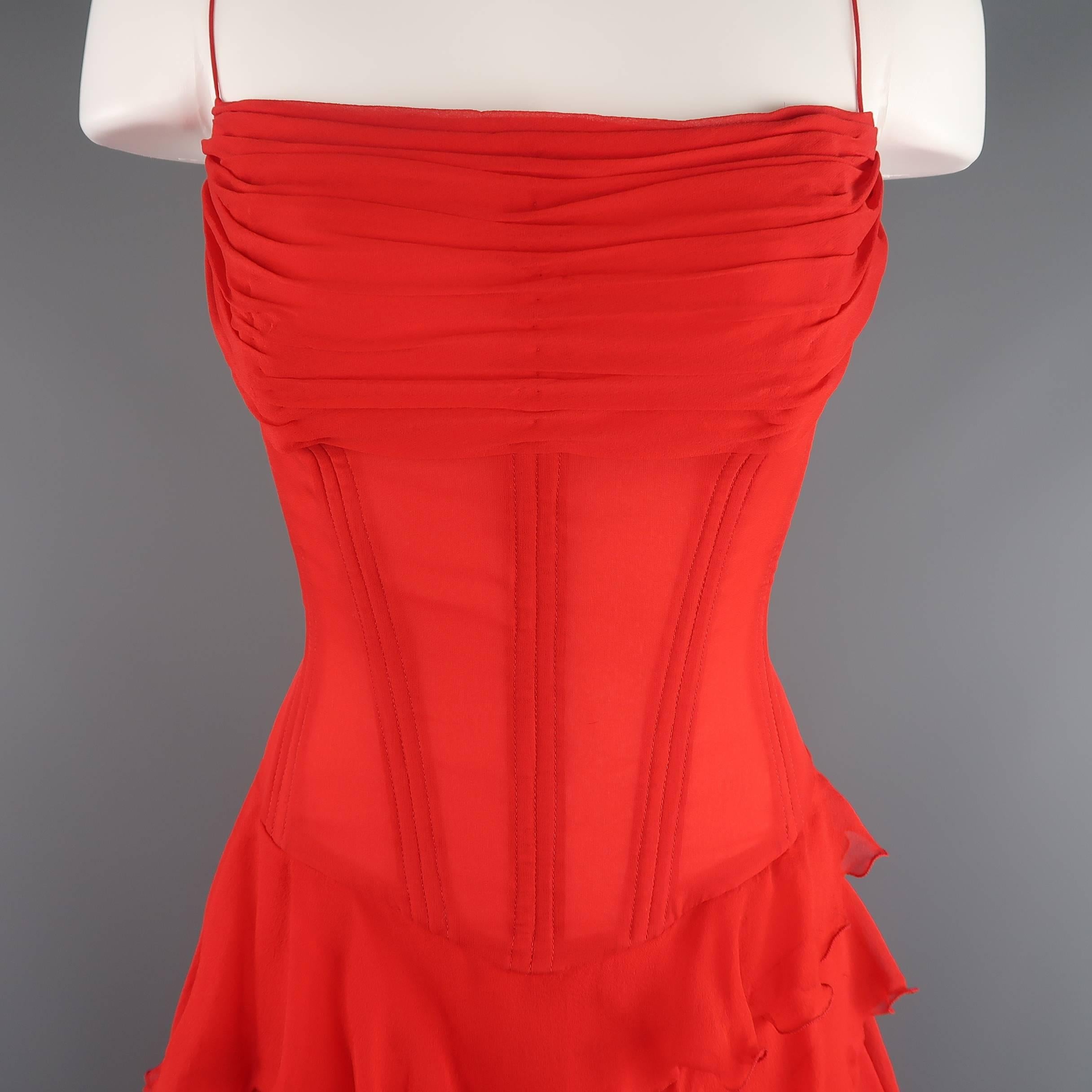 This stunning vintage Vicky Tiel Couture cocktail dress comes in a bold red, sheer silk crepe chiffon and features a boned corset bodice with pleated bust, ultra skinny straps, and an asymmetrical A line skirt of cascading ruffles. Very minor wear.
