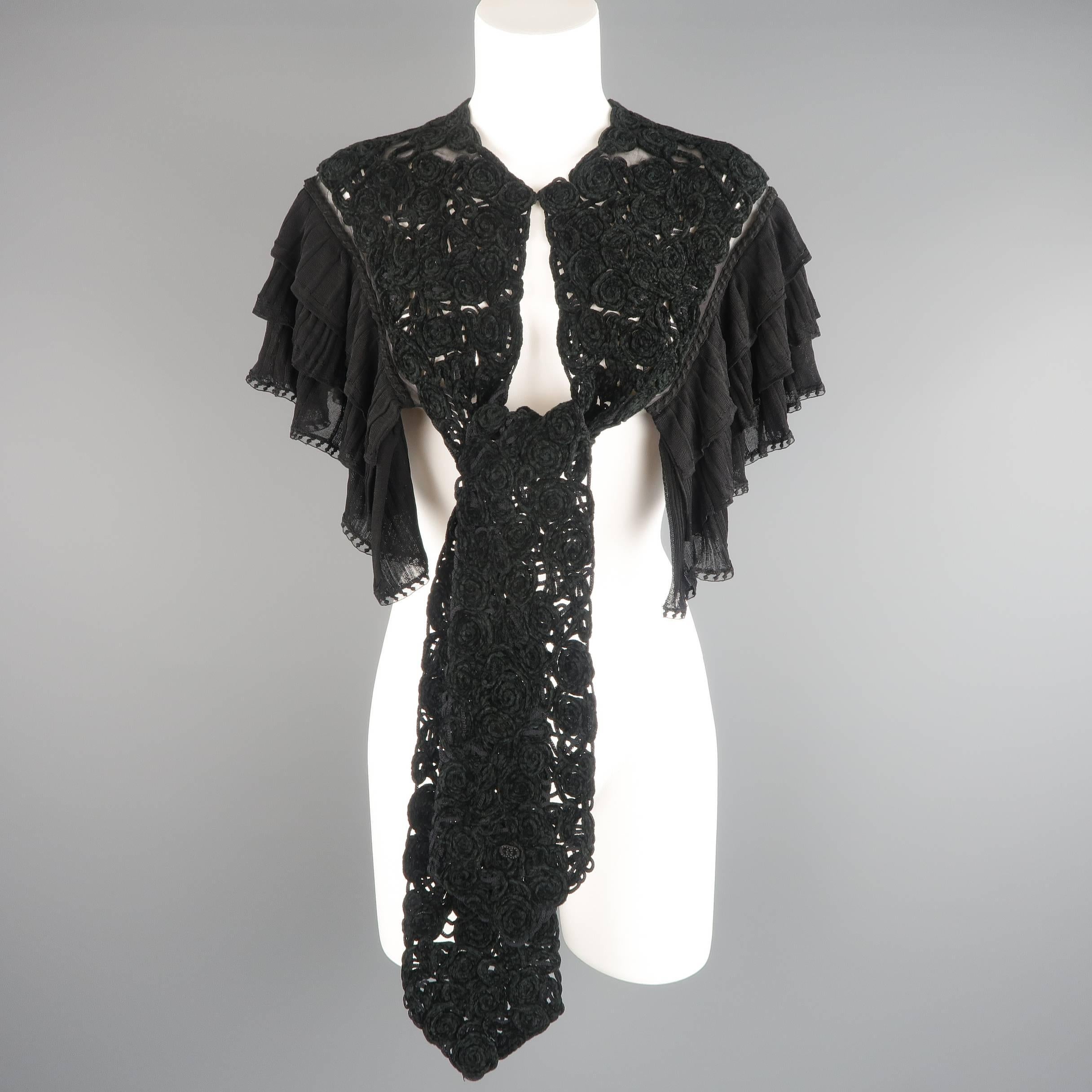 This rare CHANEL capelet comes in a velvet floral textured knit and features sheer lined shoulders. ruffled knit trim, and a long ascot collar with hook eye closure and CC emblem. Tags removed. As-is. Made in France. Good Pre-Owned Condition.
