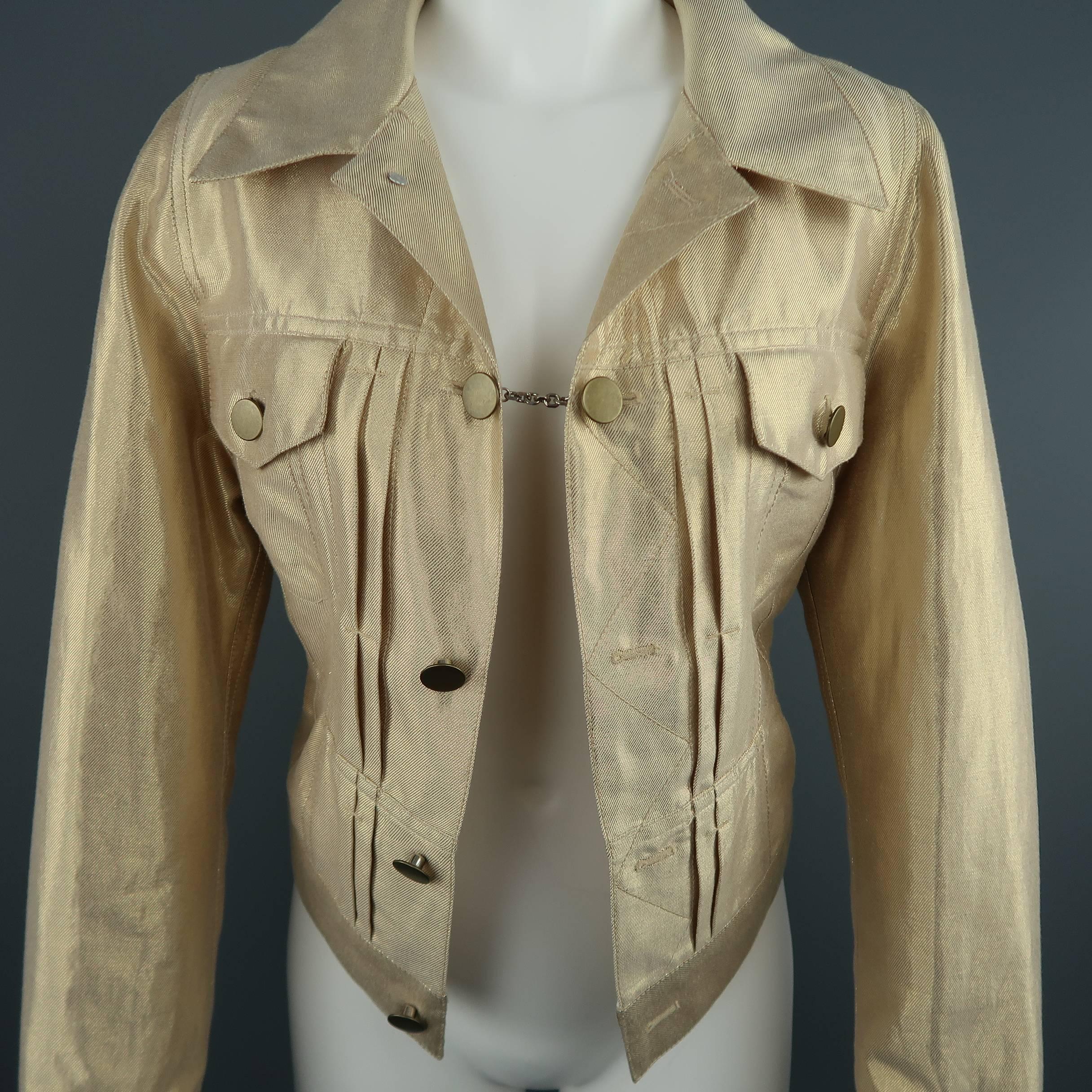 This fabulous MARC JACOBS jacket comes in a metallic gold foil blend linen twill and features a reworked denim trucker style construction with an open front, pleated details, double flap pockets, pointed collar, single chain closure, and unique