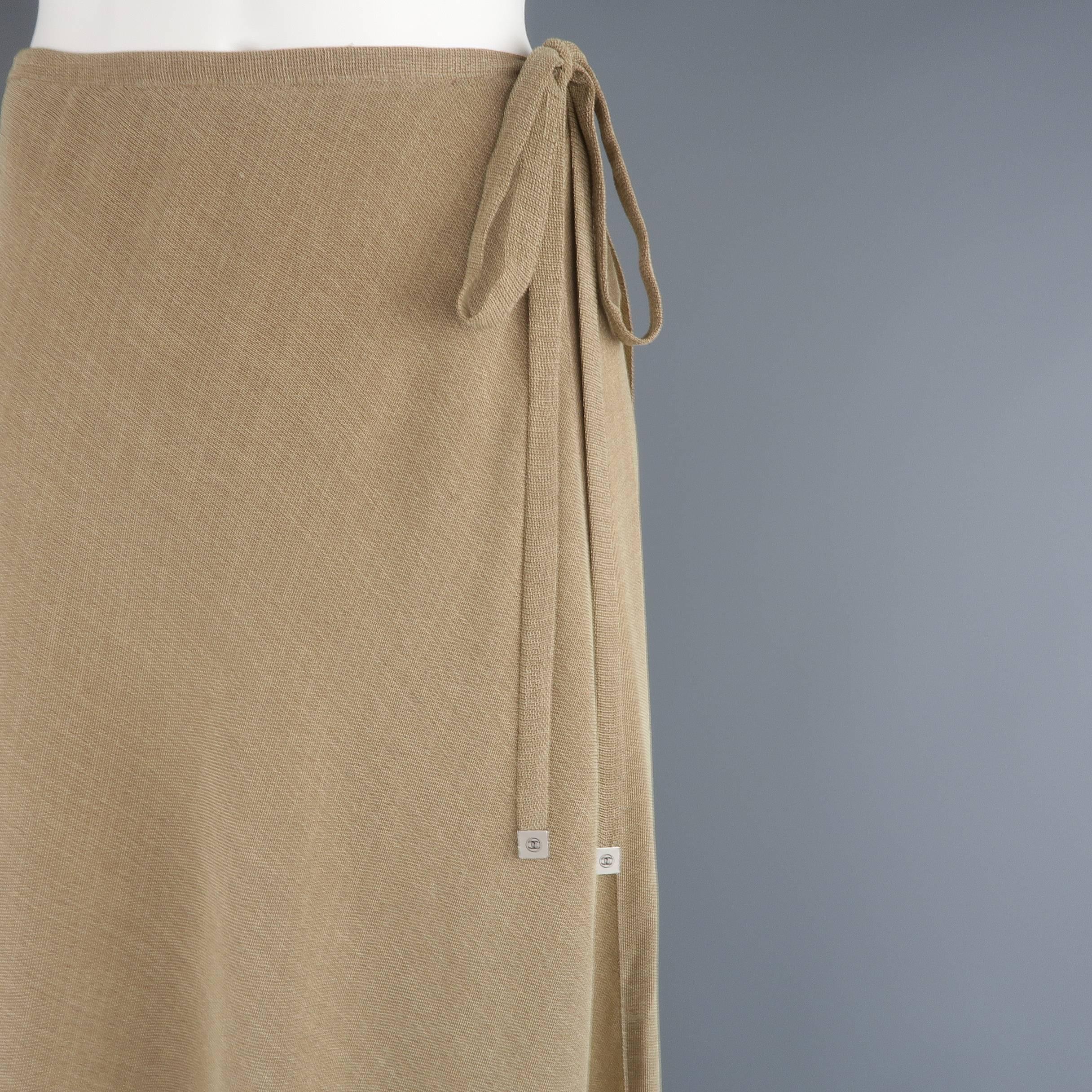 Archive CHANEL A-line maxi skirt from Spring Summer 1999 Collection comes in a woven viscose blend fabric and features a wrap front that ties to the side with silver tone CC logo ends, and a ruffled hemline. Minor wear on hardware. As-is.  Made in