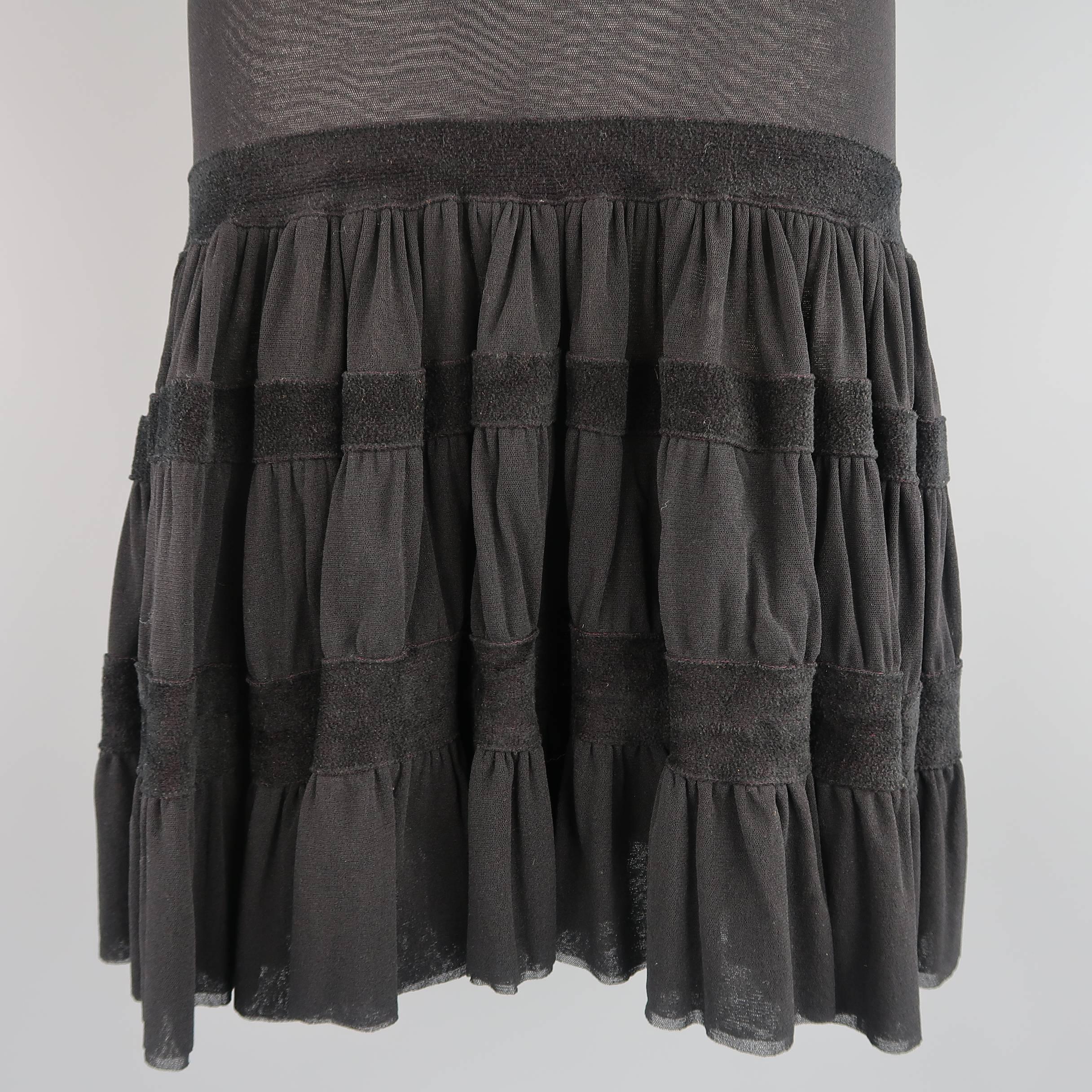 JEAN PAUL GAULTIER skirt comes in stretch micro mesh and features a fitted pencil top, drop waist, ruffle flair skirt, and thick velour trim. Made in Italy.
 
Good Pre-Owned Condition.
Marked: M
 
Measurements:
 
Waist: 28 in.
Hip: 36 in.
Length: 26