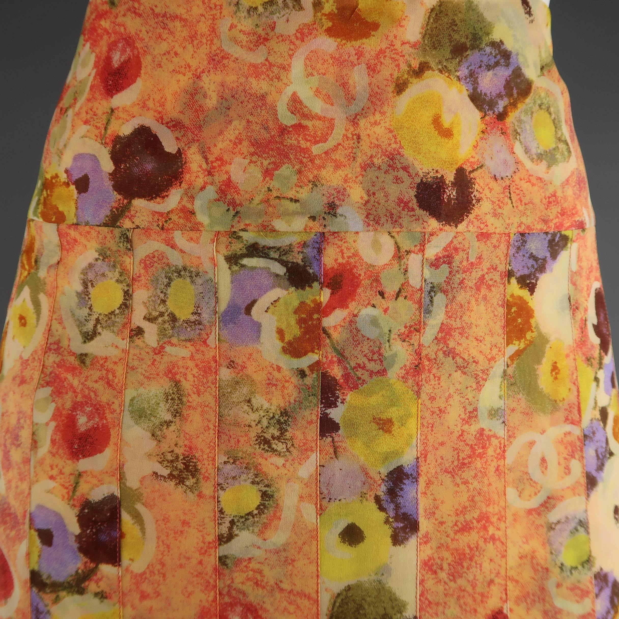 Chanel  Spring 2004 A-line skirt comes in a gorgeous orange silk chiffon with multi-color floral print and features a pleated body with flared pleat drop waist hem. Made in France.
 
Excellent Pre-Owned Condition.
Marked: FR 42 (04P)
