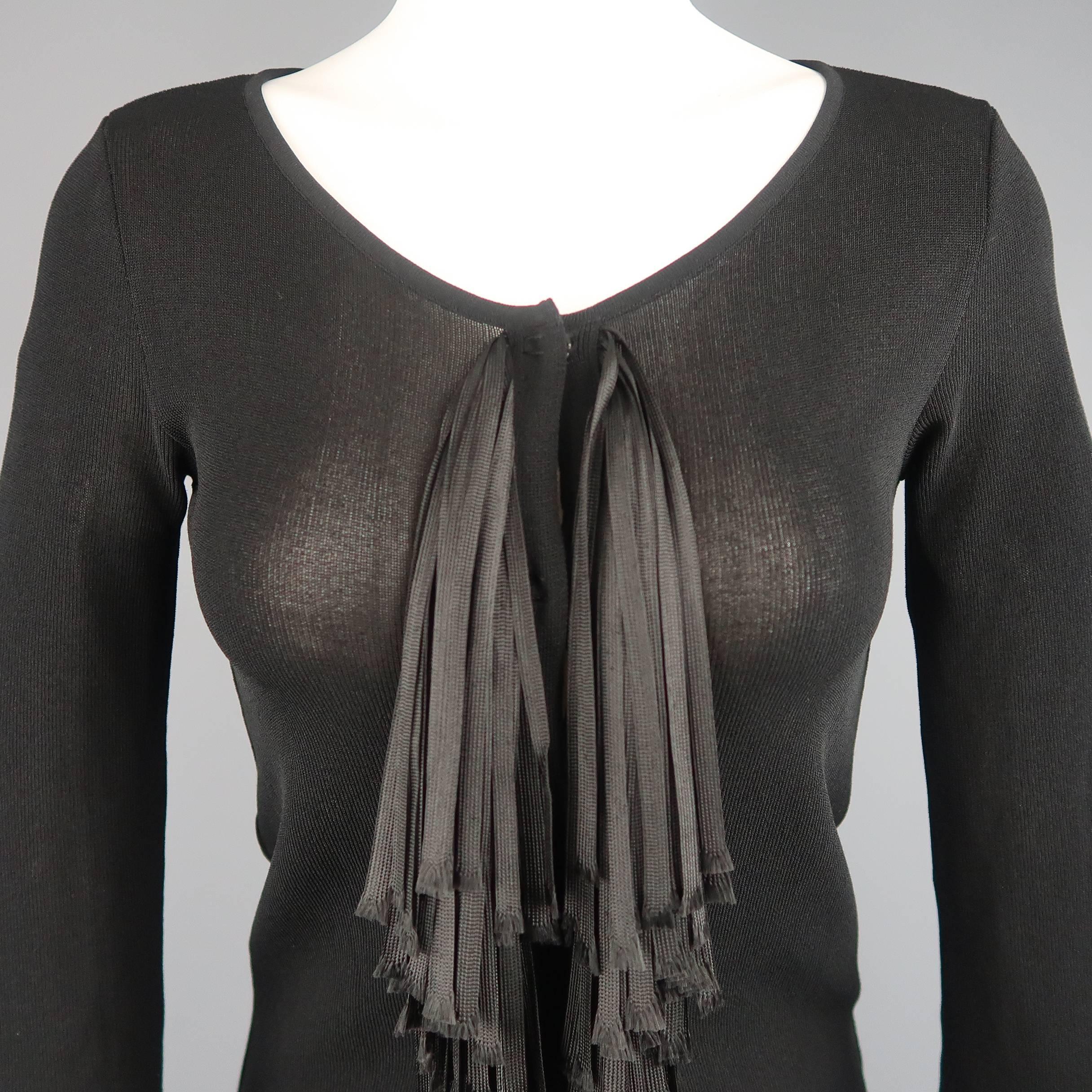 This Giambattista Valli cardigan comes in a sheer black knit and features a round scoop neck, three quarter sleeves, hidden placket snap closure front, and layered raw edge ribbon fringe down the front. Made In Italy.
 
Excellent Pre-Owned